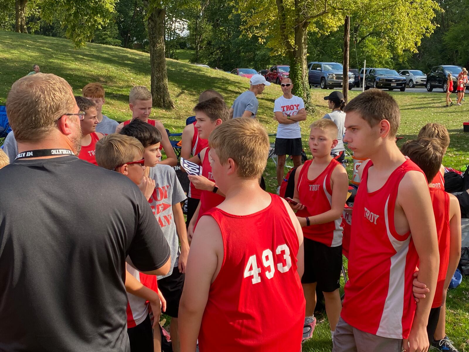 Logan Edens, right, huddles with the Troy Junior High School cross country team at Piqua Country Club on Tuesday, Sept. 14, 2021. Photo courtesy of Liz Edens