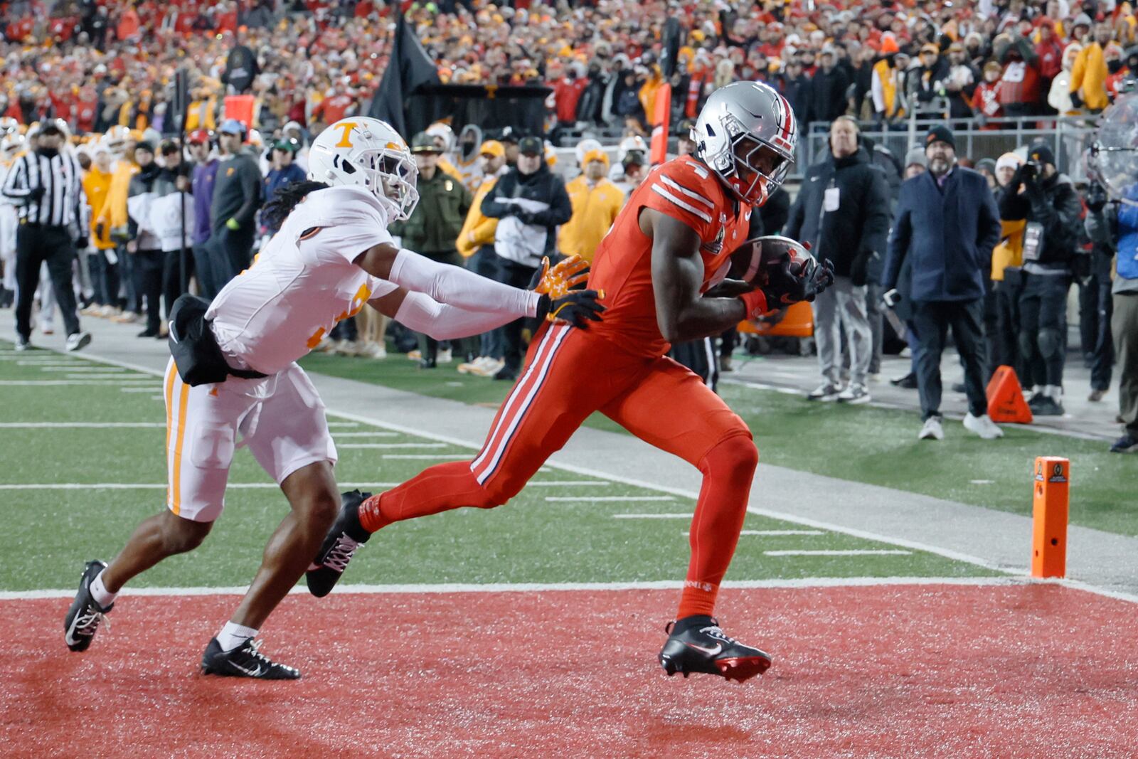 Ohio State receiver Jeremiah Smith, right, catches a touchdown pass against Tennessee defensive back Jermod McCoy, left, during the second half in the first round of the College Football Playoff, Saturday, Dec. 21, 2024, in Columbus, Ohio. (AP Photo/Jay LaPrete)