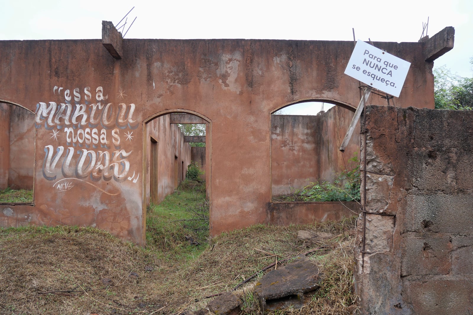 What remains of a home that was destroyed when a dam broke carries signs that read in Portuguese "That marked our lives" and "So that it is never forgotten" in Bento Rodrigues, Minas Gerais state, Brazil, Oct. 19, 2024. Victims of Brazil’s worst environmental disaster, on Nov. 5, 2015, took their case for compensation to a UK court on Monday, Oct. 21, 2024, almost nine years after tons of toxic mining waste poured into a major waterway, killing 19 people and devastating local communities. (AP Photo/Eleonore Hughes)