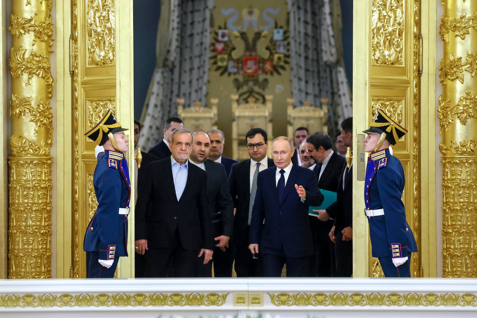 Iranian President Masoud Pezeshkian, center left,, and Russian President Vladimir Putin, center right, arrive to attend a signing ceremony following their talks at the Kremlin in Moscow, Russia, Friday, Jan. 17, 2025. (Vyacheslav Prokofyev, Sputnik, Kremlin Pool Photo via AP)