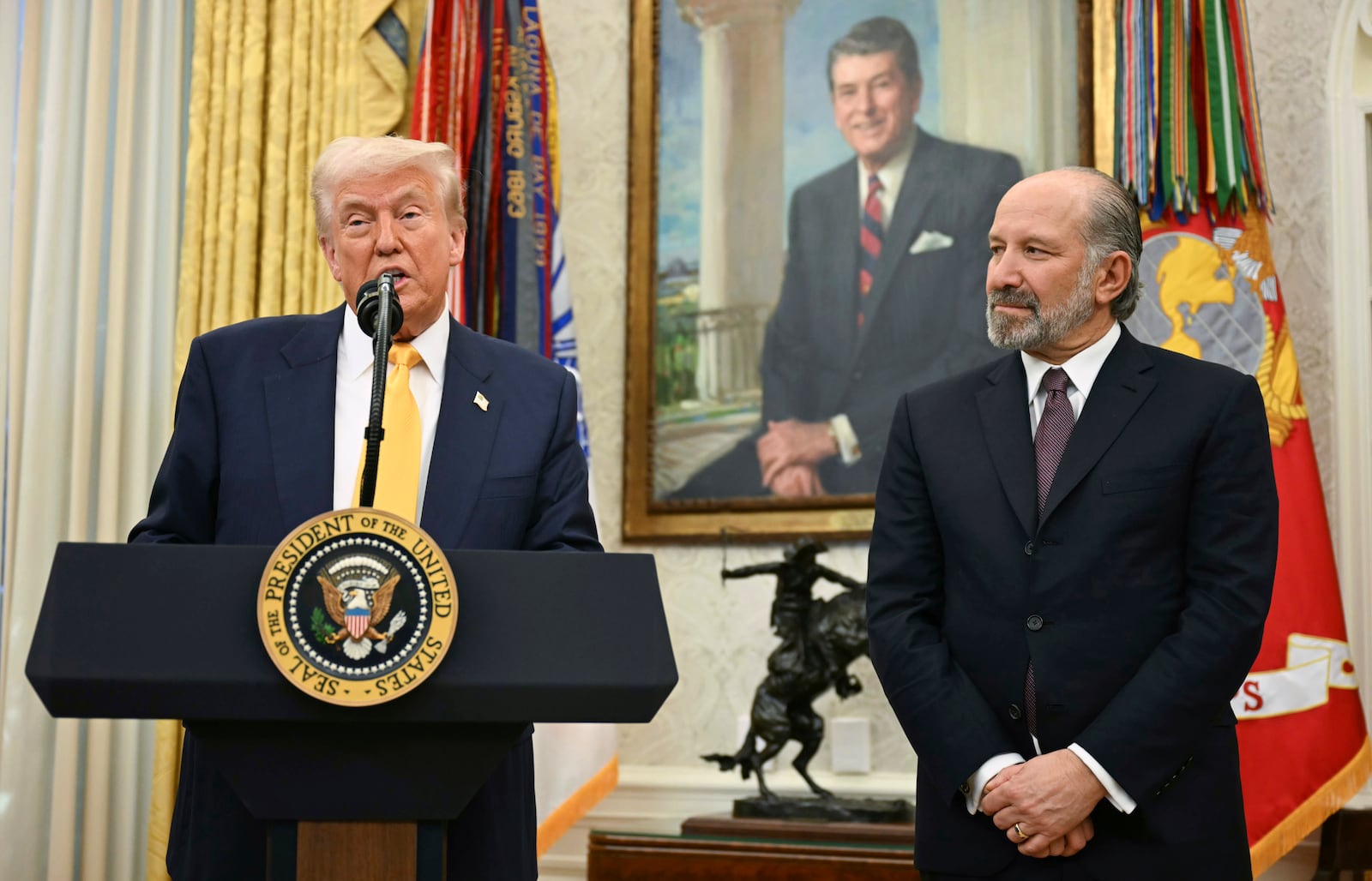 President Donald Trump speaks during a ceremonial swearing-in for Secretary of Commerce Howard Lutnick in the Oval Office of the White House in Washington, Friday, Feb. 21, 2025. (Pool via AP)