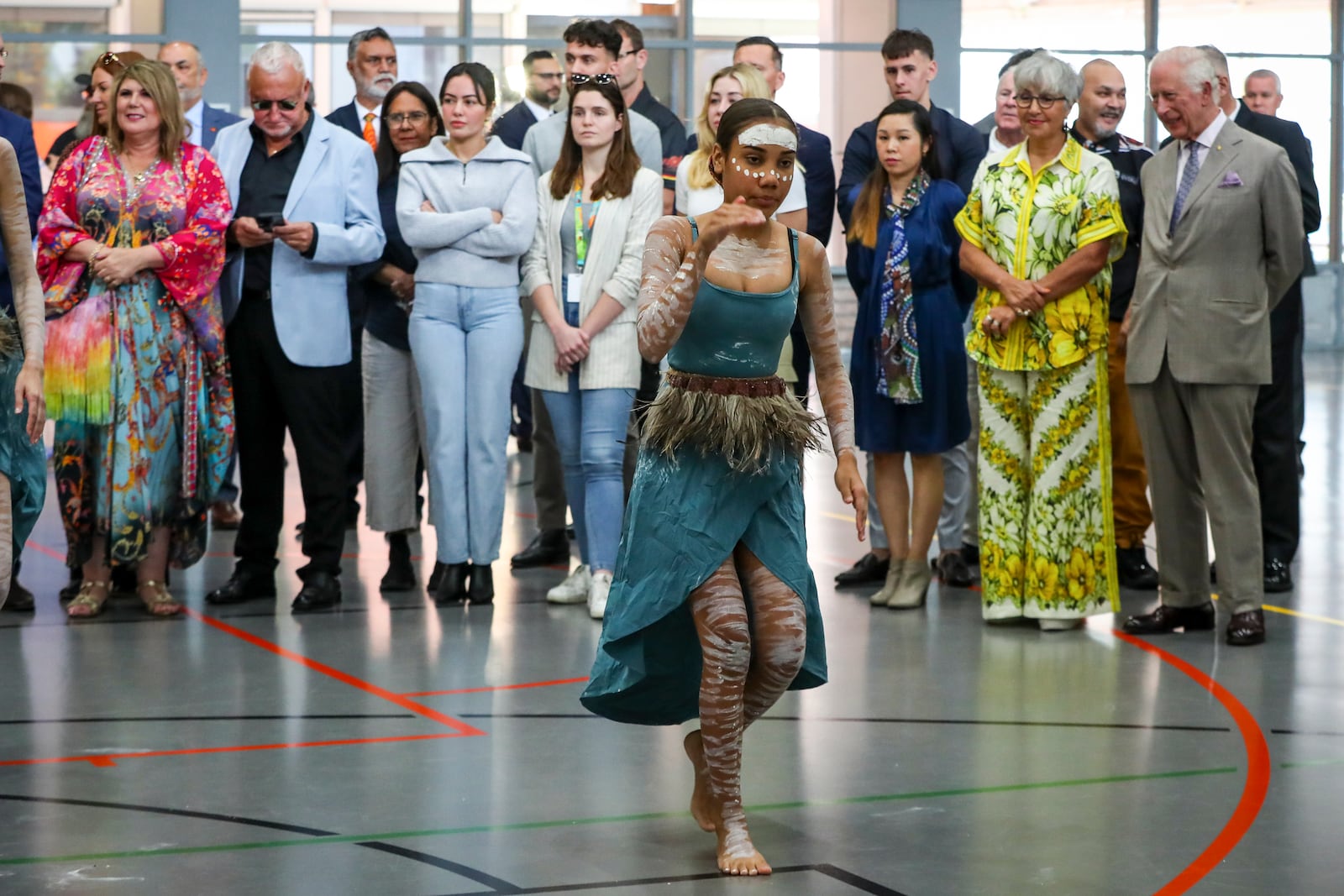 Britain's King Charles III, right, watches a performance by the Brogla Dance Academy group during a visit to the National Centre of Indigenous Excellence on Tuesday Oct. 22, 2024 in Sydney, Australia. (Lisa Maree Williams/Pool Photo via AP)