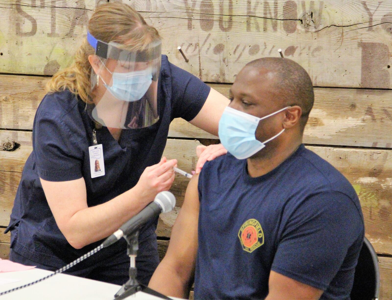 Springfield Firefighter Chris Chilton receives the coronavirus vaccine live during Gov. Mike DeWine’s update on the pandemic on Wednesday. Hasan Karim/ Staff