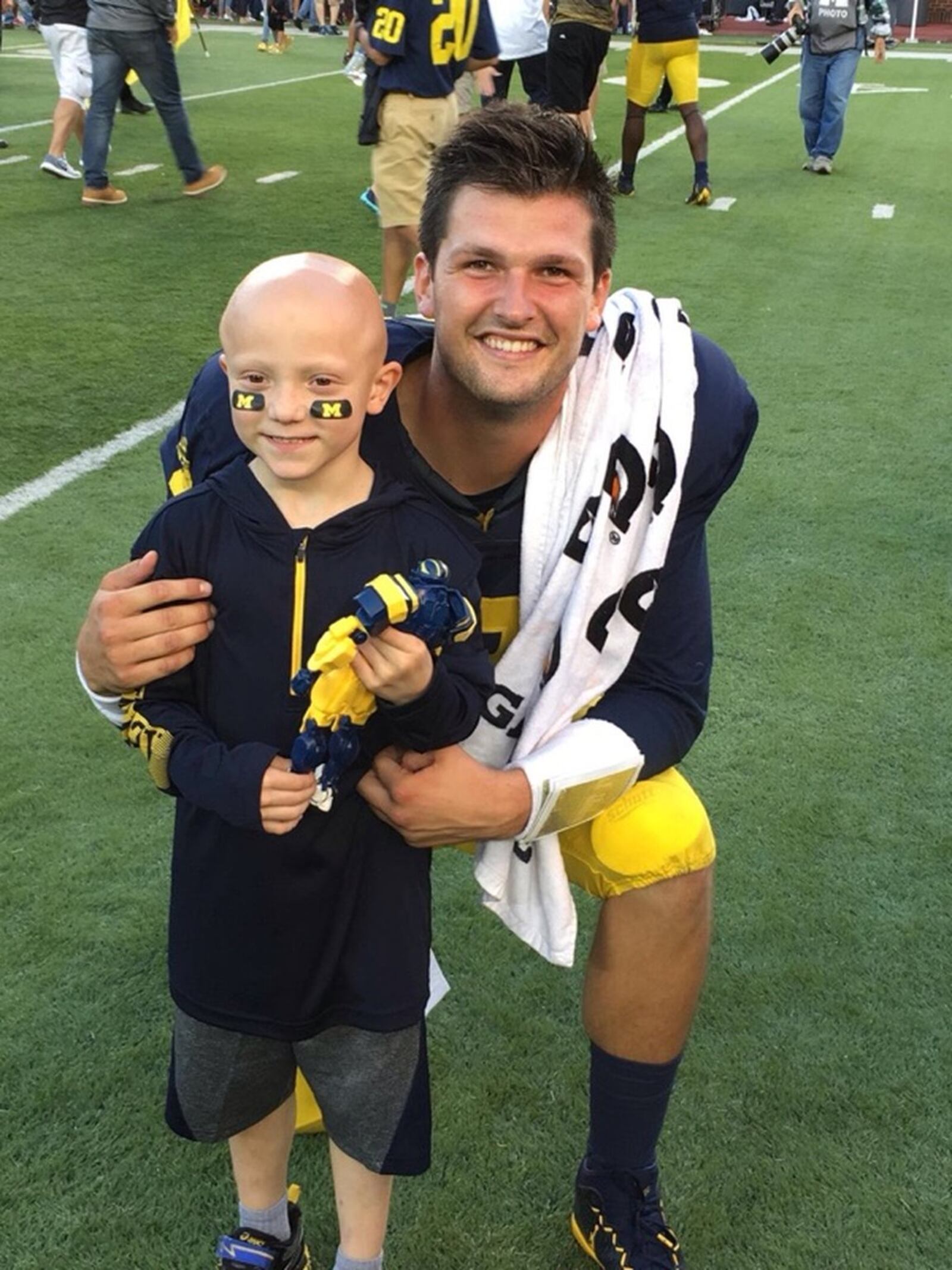 Barrett Fitzsimmons, 7, poses for a photo with Michigan quarterback Wilton Speight on Saturday, Sept. 17, 2016, at Michigan Stadium in Ann Arbor, Mich. Submitted photo