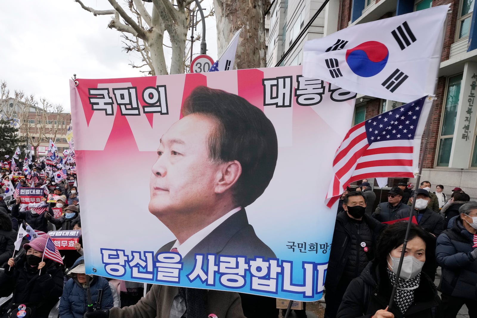 FILE - Supporters of impeached South Korean President Yoon Suk Yeol attend a rally to oppose his impeachment near the Constitutional Court in Seoul, South Korea, on Feb. 25, 2025. The letters read "The people's president." (AP Photo/Ahn Young-joon, File)