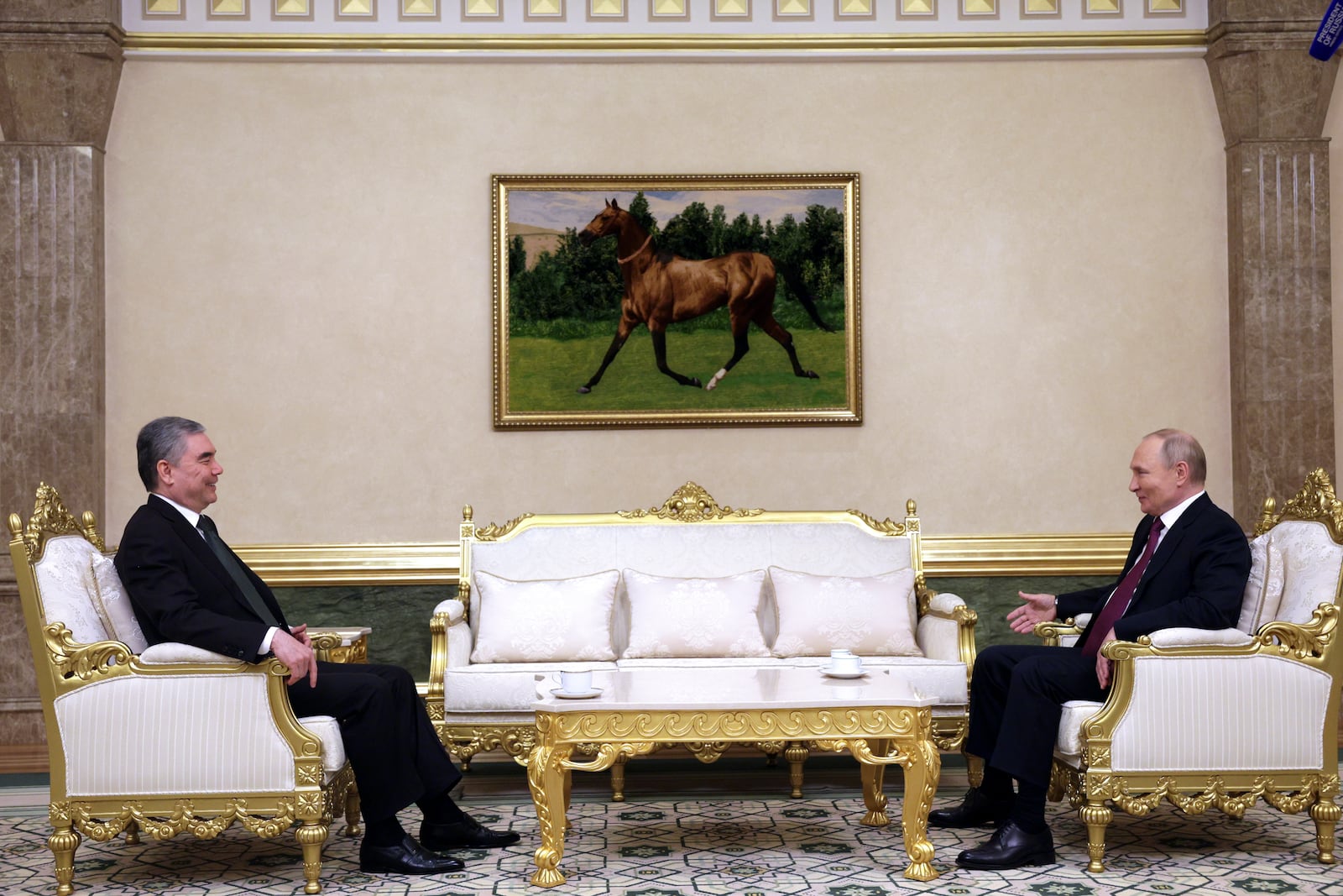 Russian President Vladimir Putin, right, and Chairman of the People's Council of Turkmenistan Gurbanguly Berdymukhamedov talk to each other during their meeting on the sidelines of the International Forum "The Interconnection of Times and Civilizations – the basis of peace and development" dedicated to the 300th anniversary of the birth of the outstanding Turkmen poet and thinker Magtymguly Fragi in Ashgabat, Turkmenistan, Friday, Oct. 11, 2024. (Gavriil Grigorov, Sputnik, Kremlin Pool Photo via AP)