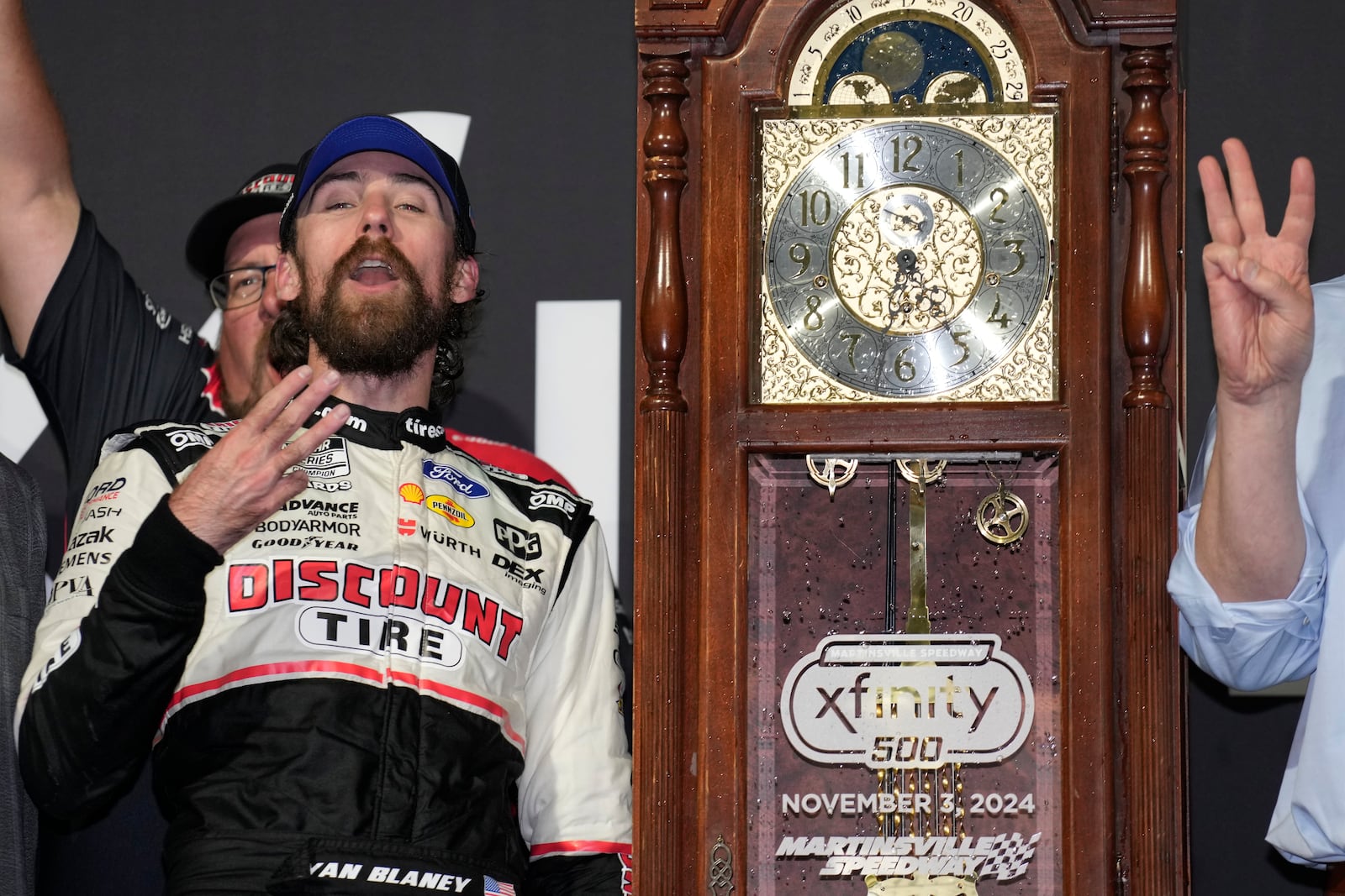 Ryan Blaney, front left, celebrates in Victory Lane after winning a NASCAR Cup Series auto race at Martinsville Speedway in Martinsville, Va., Sunday, Nov. 3, 2024. (AP Photo/Chuck Burton)