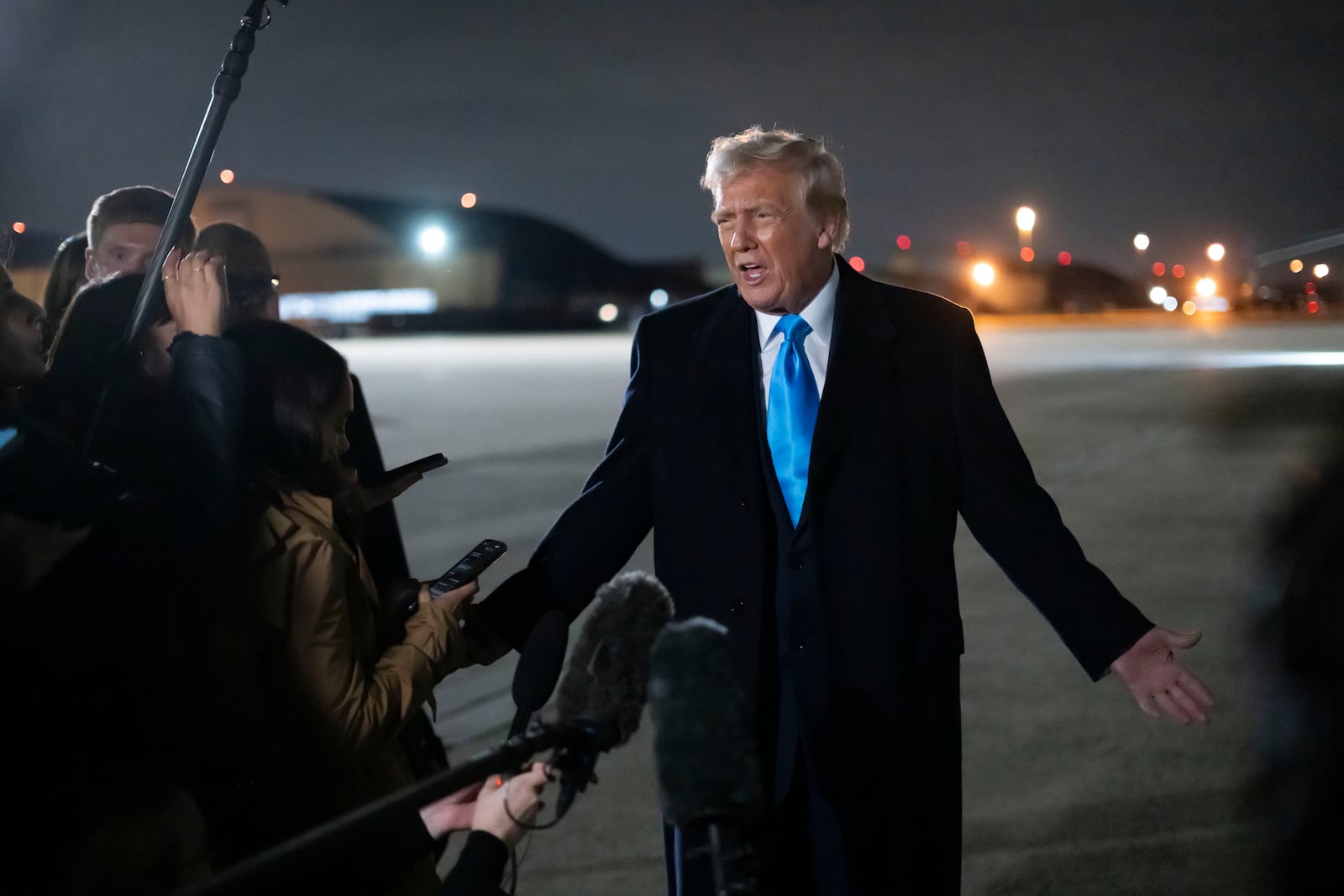 President Donald Trump speaks to reporters next to Air Force One after arriving back at Joint Base Andrews, Md., Sunday, Feb. 2, 2025. (AP Photo/Ben Curtis)