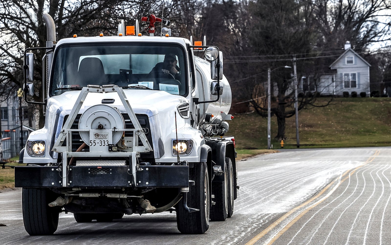 FILE - Steve Beckett with the street department in Owensboro, Ky., sprays a salt brine solution along Hickman Avenue in preparation for predicted snow and ice over the weekend, Friday, Jan. 3, 2025, in Owensboro, Ky. (Greg Eans/The Messenger-Inquirer via AP, File)