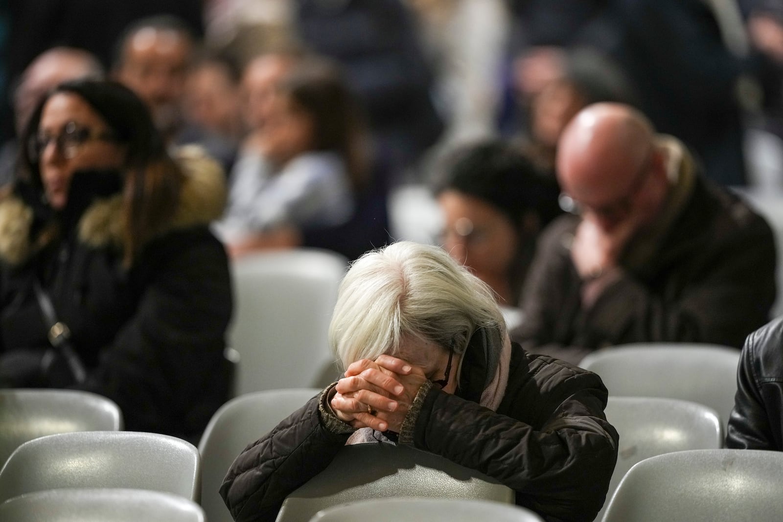 Faithful gather at St. John Lateran Basilica in Rome Sunday, Feb. 23, 2025, to pray for Pope Francis who was admitted over a week ago at Rome's Agostino Gemelli Polyclinic and is in critical condition. (AP Photo/Alessandra Tarantino)