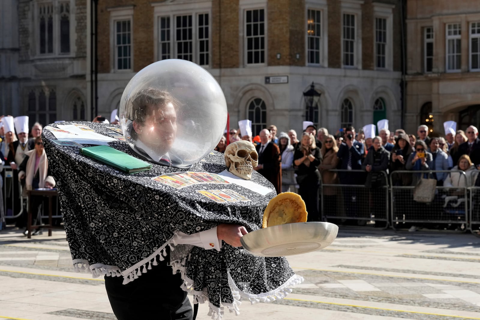 A runner competes during a traditional pancake race by livery companies at the Guildhall in London, Tuesday, March 4, 2025.(AP Photo/Frank Augstein)