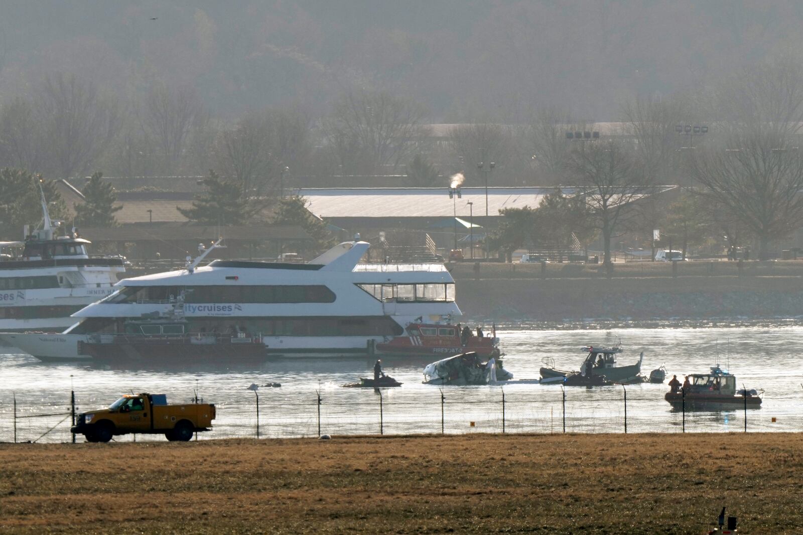 Search and rescue efforts are seen around a wreckage site in the Potomac River from Ronald Reagan Washington National Airport, early Thursday morning, Jan. 30, 2025, in Arlington, Va. (AP Photo/Mark Schiefelbein)