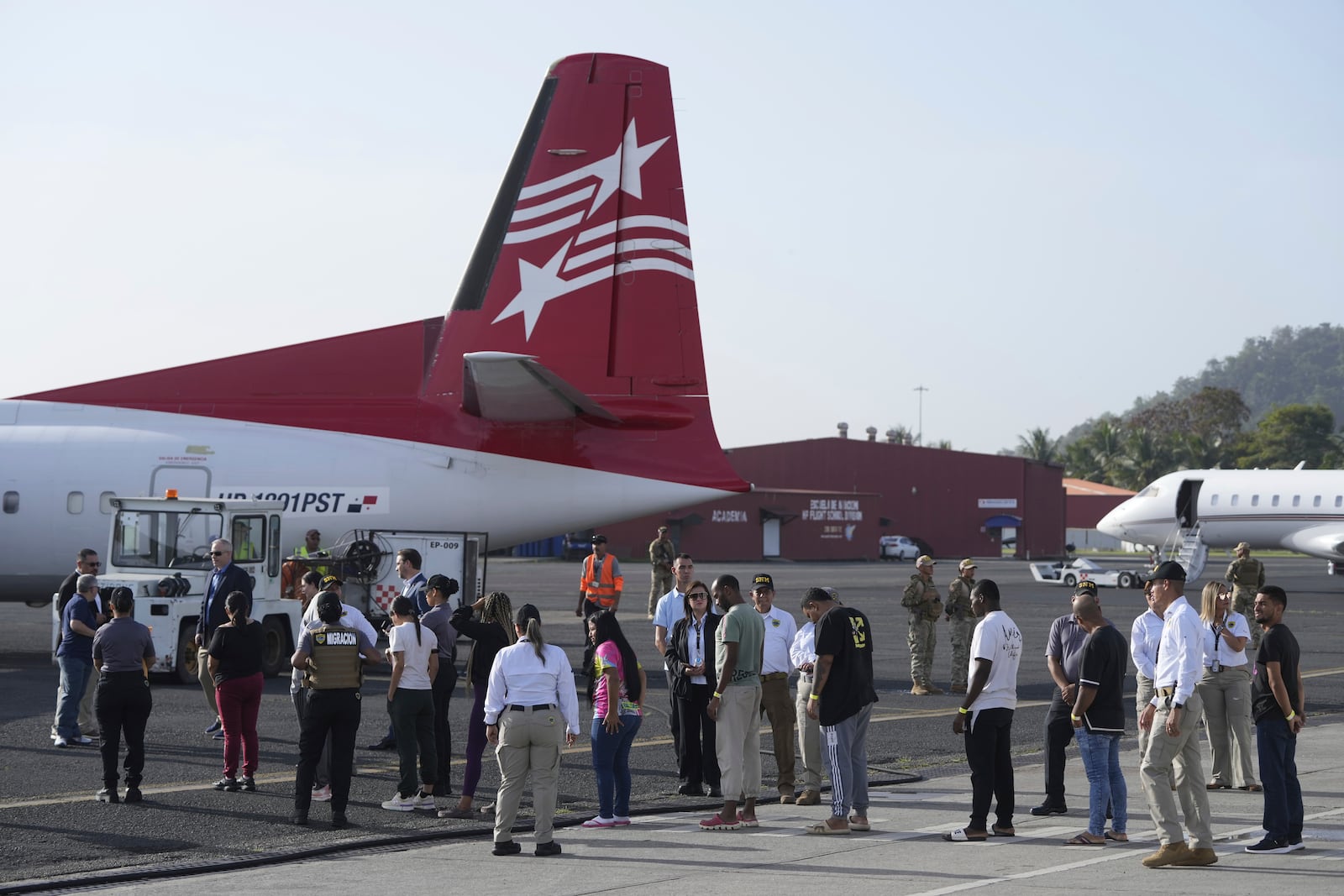 People arrive to board a repatriation flight bound for Colombia at Albrook Airport in Panama City, Monday, Feb. 3, 2025. (AP Photo/Mark Schiefelbein, Pool)