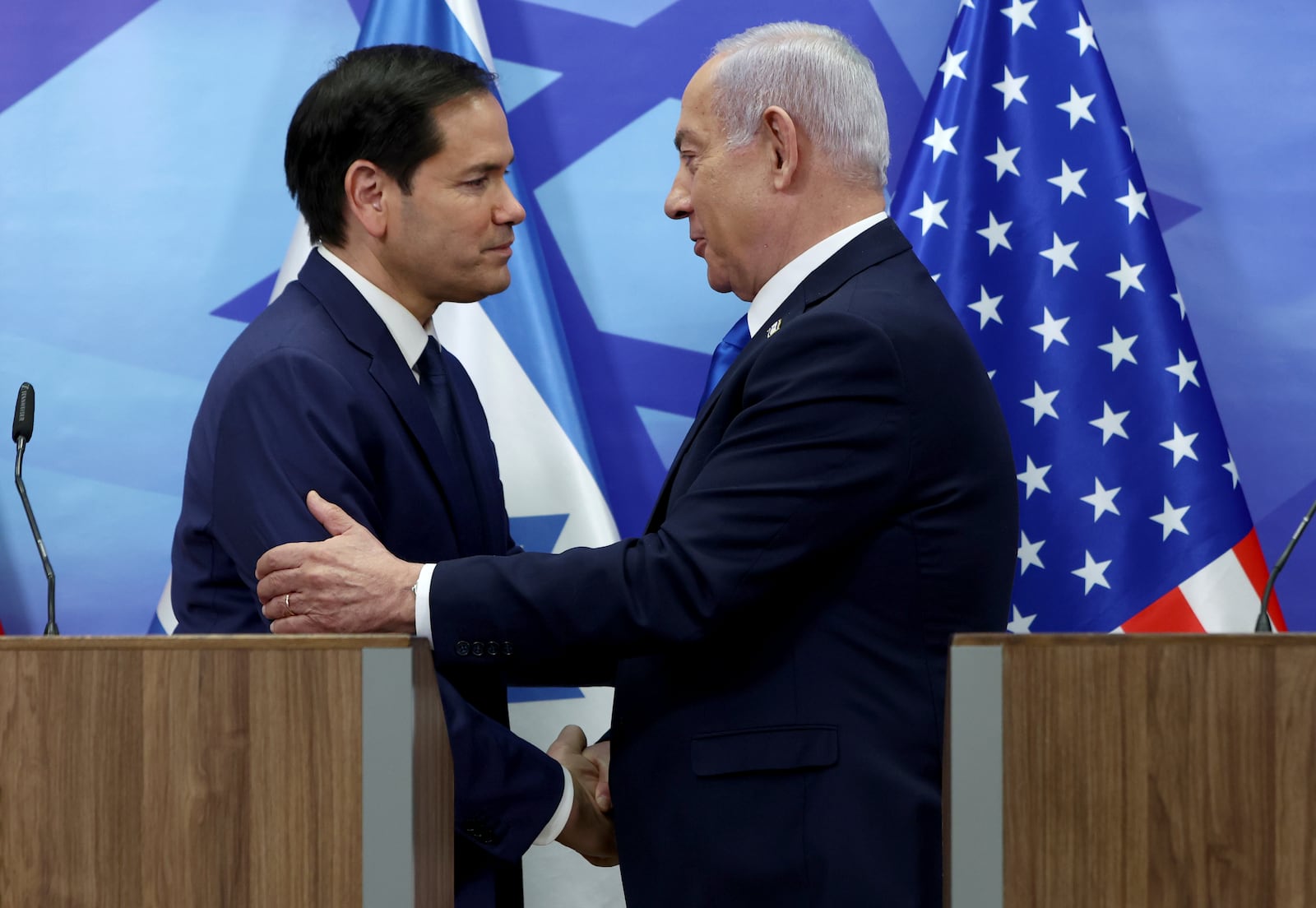 U.S. Secretary of State Marco Rubio, left, and Israeli Prime Minister Benjamin Netanyahu shake hands during a news conference at the Prime Minister's office in Jerusalem, Israel, Sunday, Feb. 16, 2025. (Evelyn Hockstein/Pool Photo via AP)