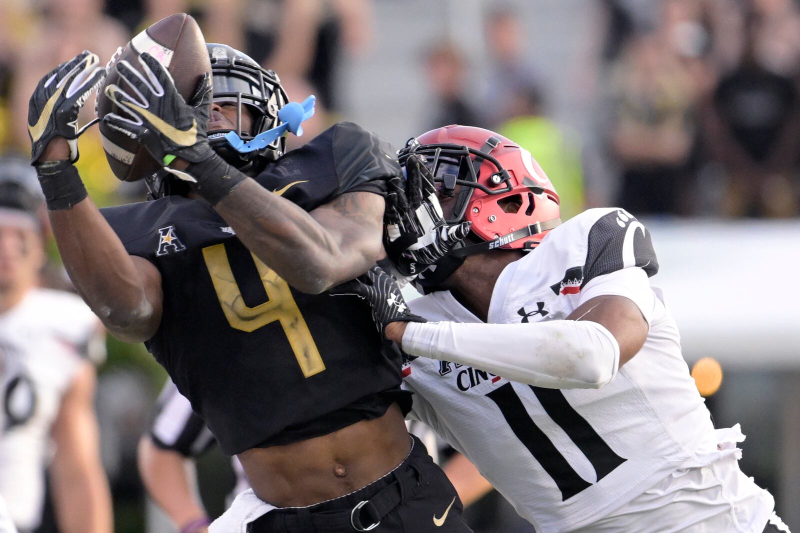 Central Florida wide receiver Ryan O'Keefe (4) cannot hold onto a pass as Cincinnati cornerback Sammy Anderson (11) defends during the second half of an NCAA college football game, Saturday, Oct. 29, 2022, in Orlando, Fla. (AP Photo/Phelan M. Ebenhack)