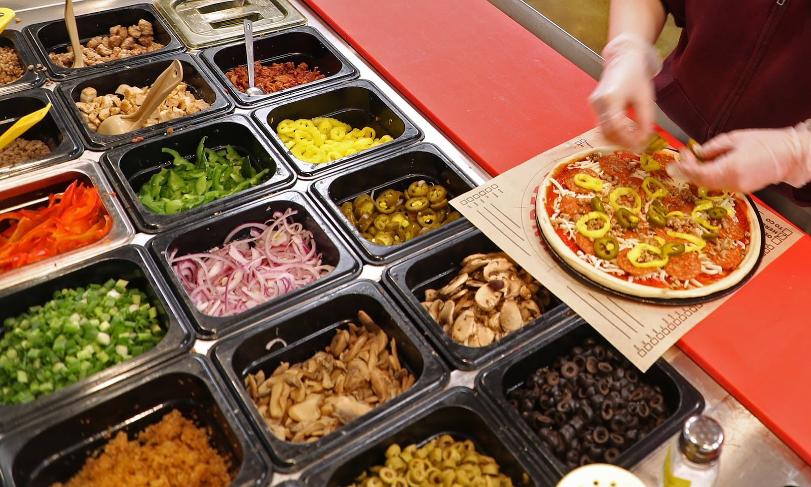 Dozens of topping choices for your pizza at Rapid Fired Pizza. BILL LACKEY/STAFF