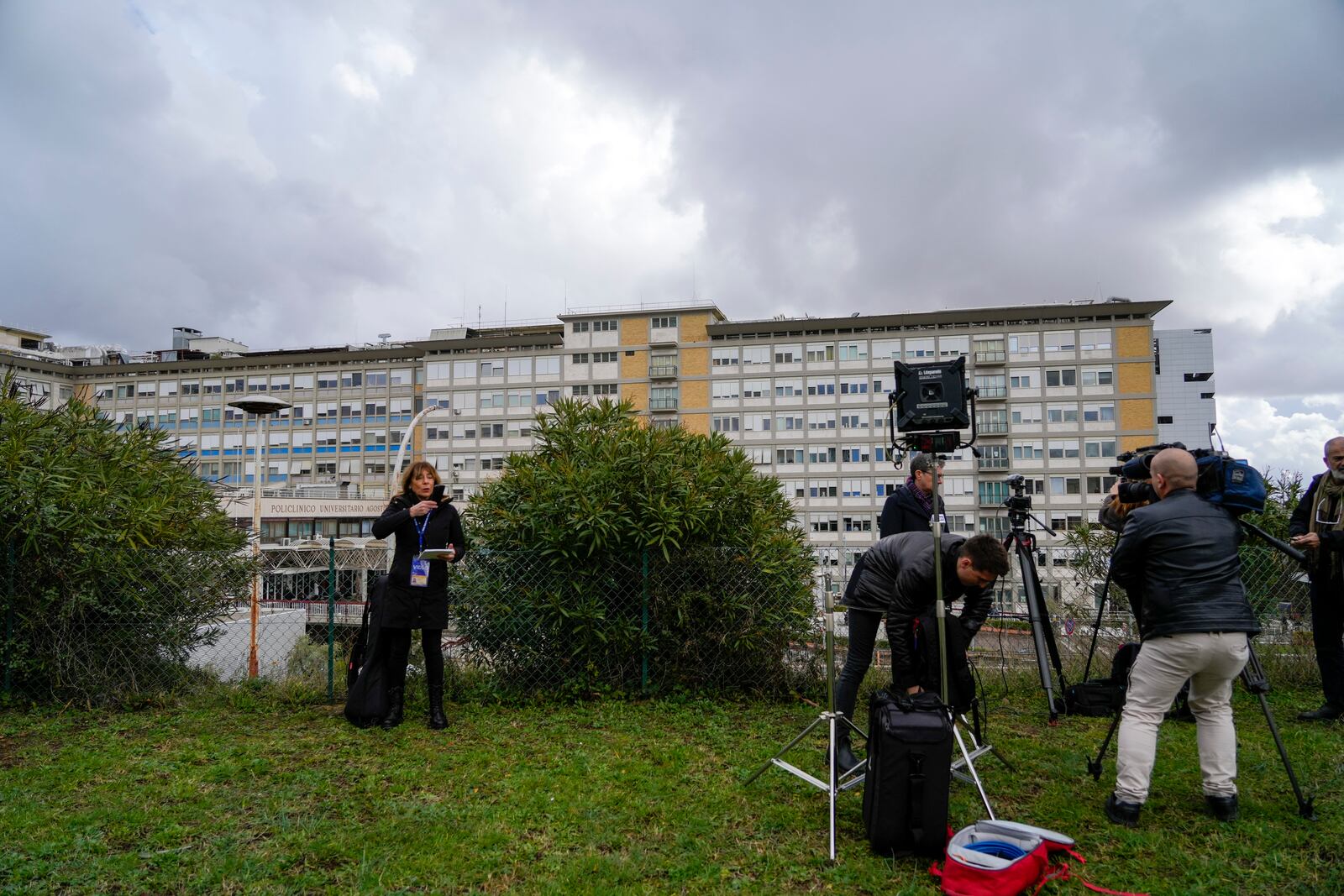 Members of the media take position outside the Agostino Gemelli Polyclinic in Rome, Friday, Feb. 14, 2025, where Pope Francis has been hospitalized to undergo some necessary diagnostic tests and to continue his ongoing treatment for bronchitis. (AP Photo/Gregorio Borgia)