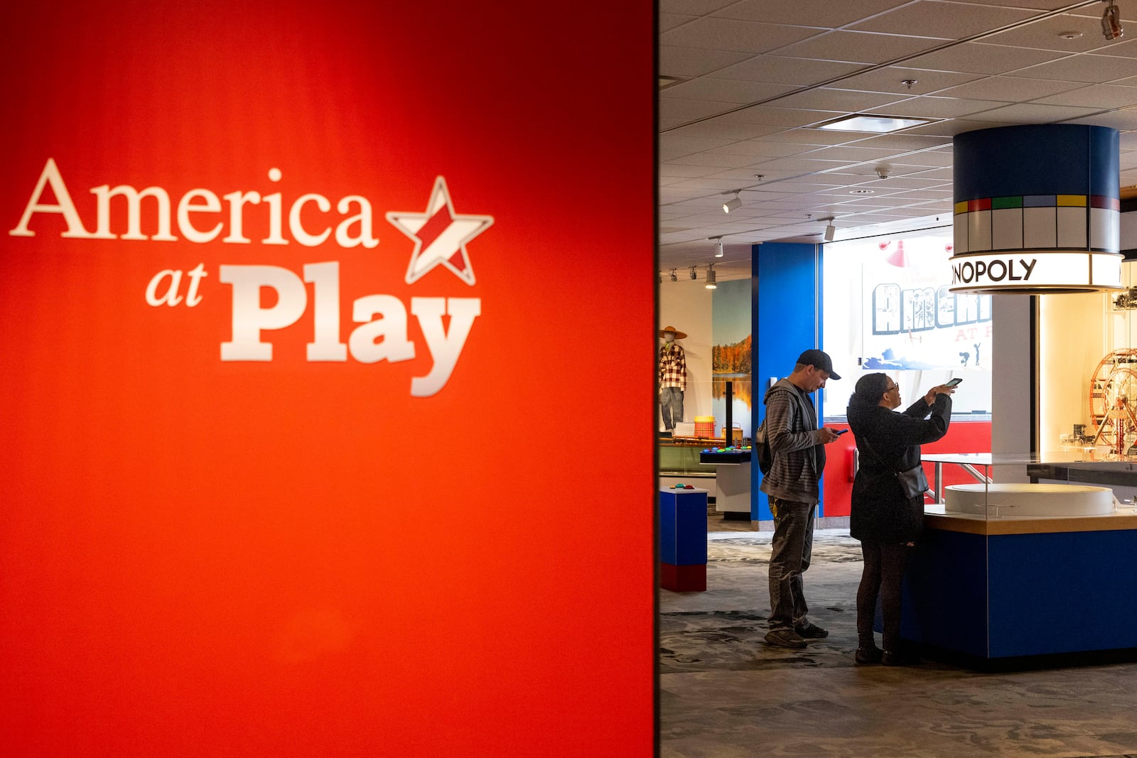 A visitor takes a picture of an original Monopoly set on display at The Strong National Museum of Play, Tuesday, Oct. 15, 2024, in Rochester, N.Y. (AP Photo/Lauren Petracca)