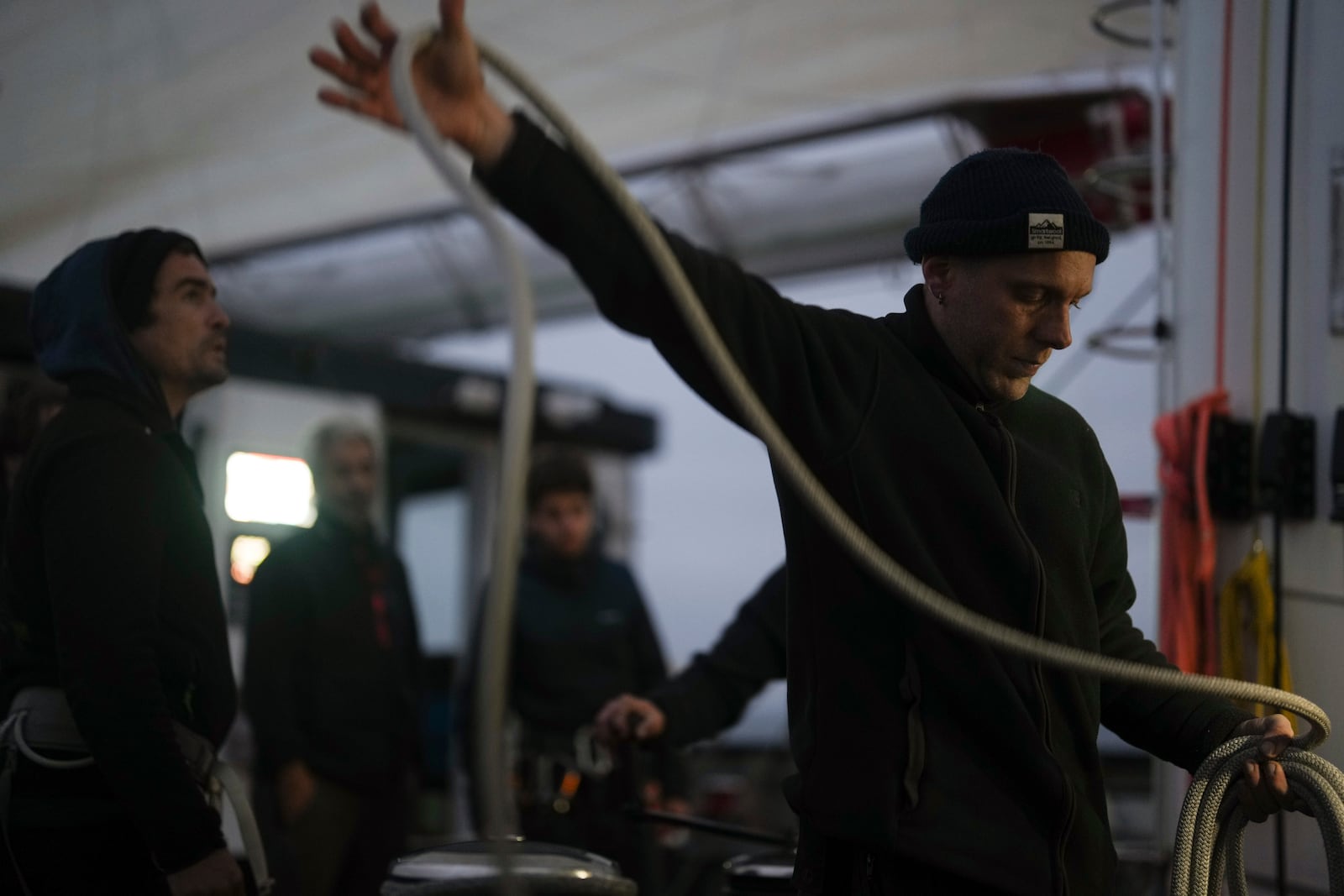 Sailor Leo Jouglet folds the ropes aboard the sailboat 'Grain de Sail II' as it sails off Saint Malo, western France, Nov. 6, 2024. (AP Photo/Thibault Camus)