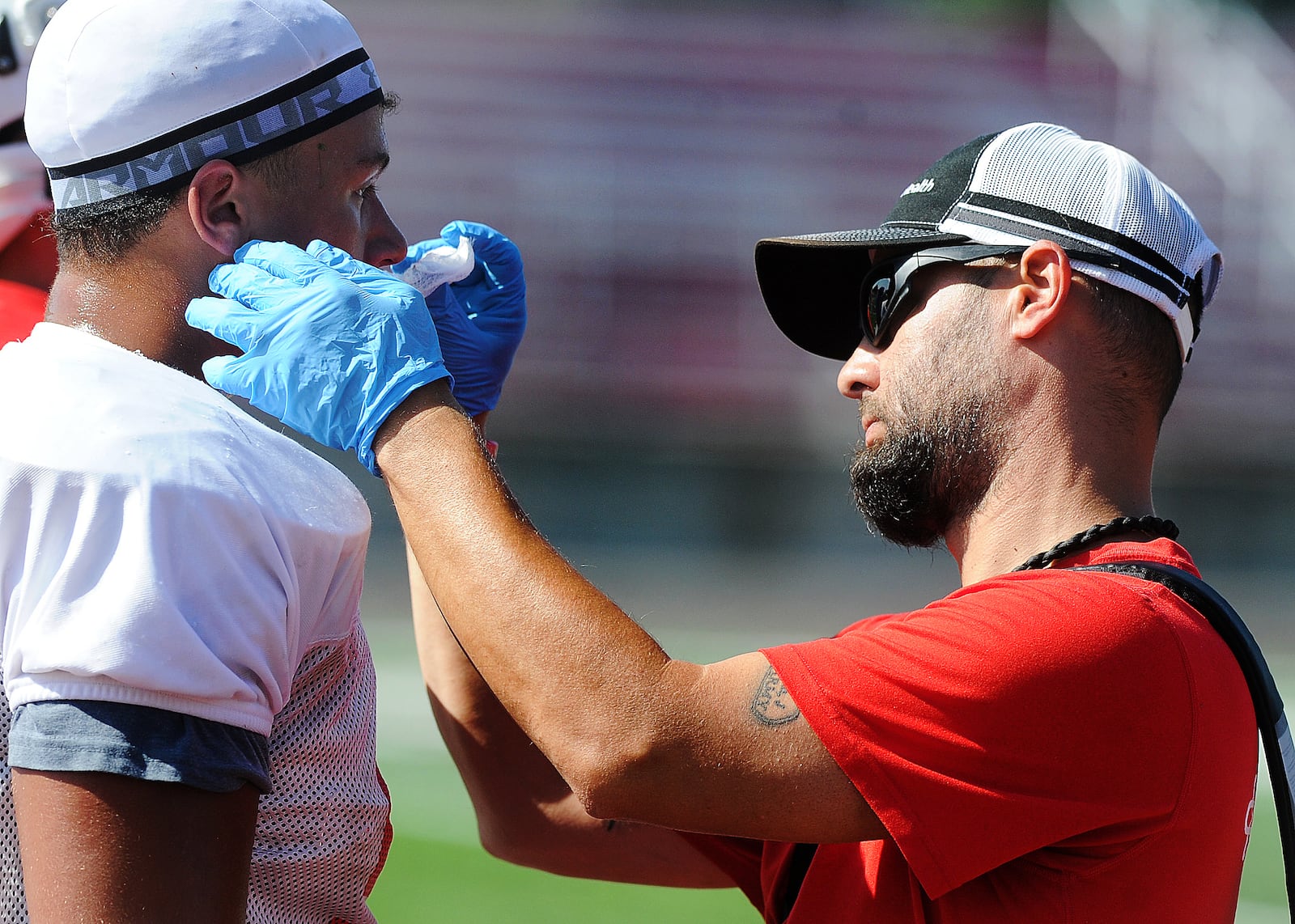 Wayne High School athletic trainer Jonny Nemeth, right, takes of one of the players at practice Monday, July 31, 2023. MARSHALL GORBY\STAFF