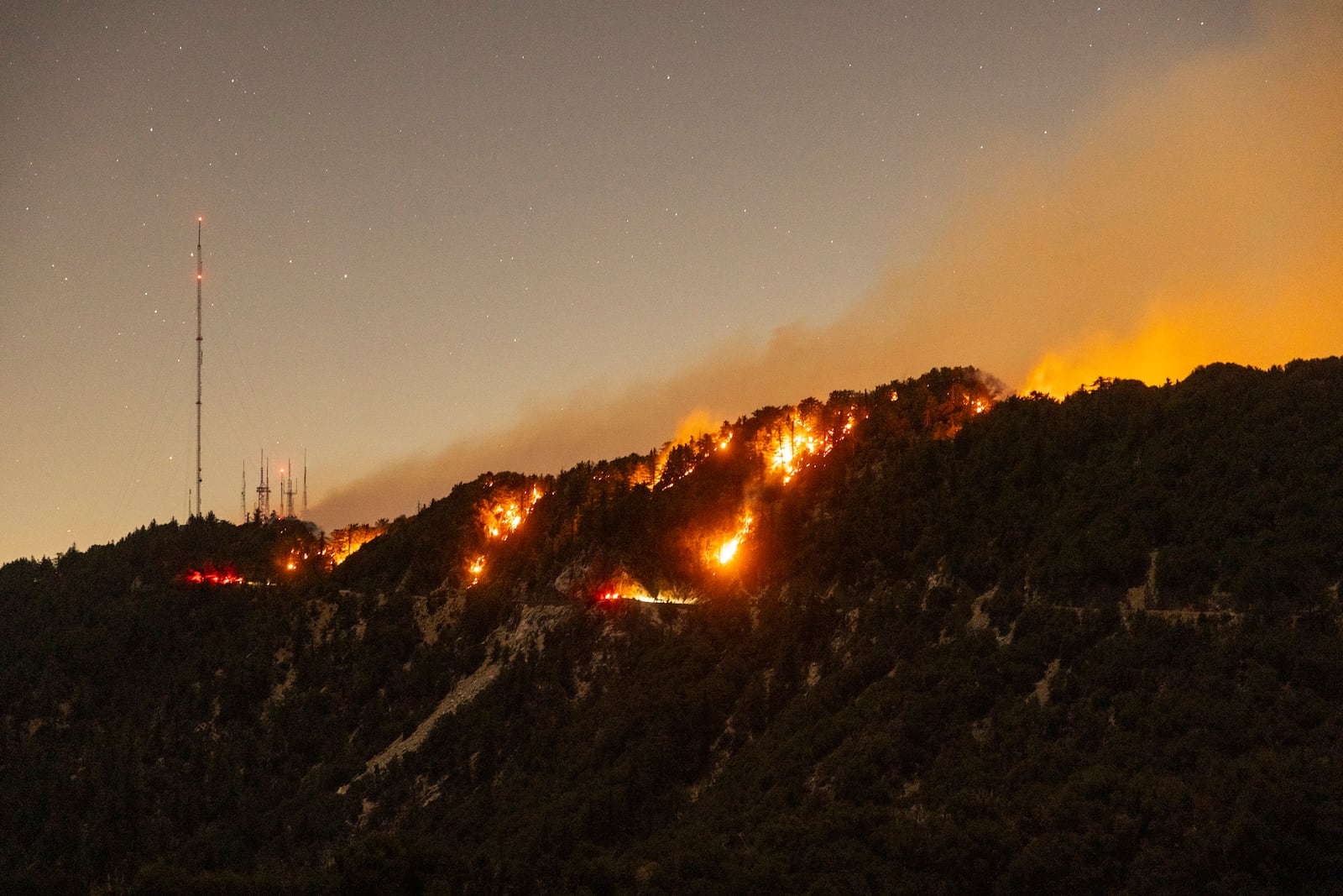 Spots of the Eaton Fire still burn after the fire swept through the mountains of the Angeles National Forest near Mount Wilson Observatory, north of Pasadena, Thursday, Jan. 9, 2025. (AP Photo/Etienne Laurent)