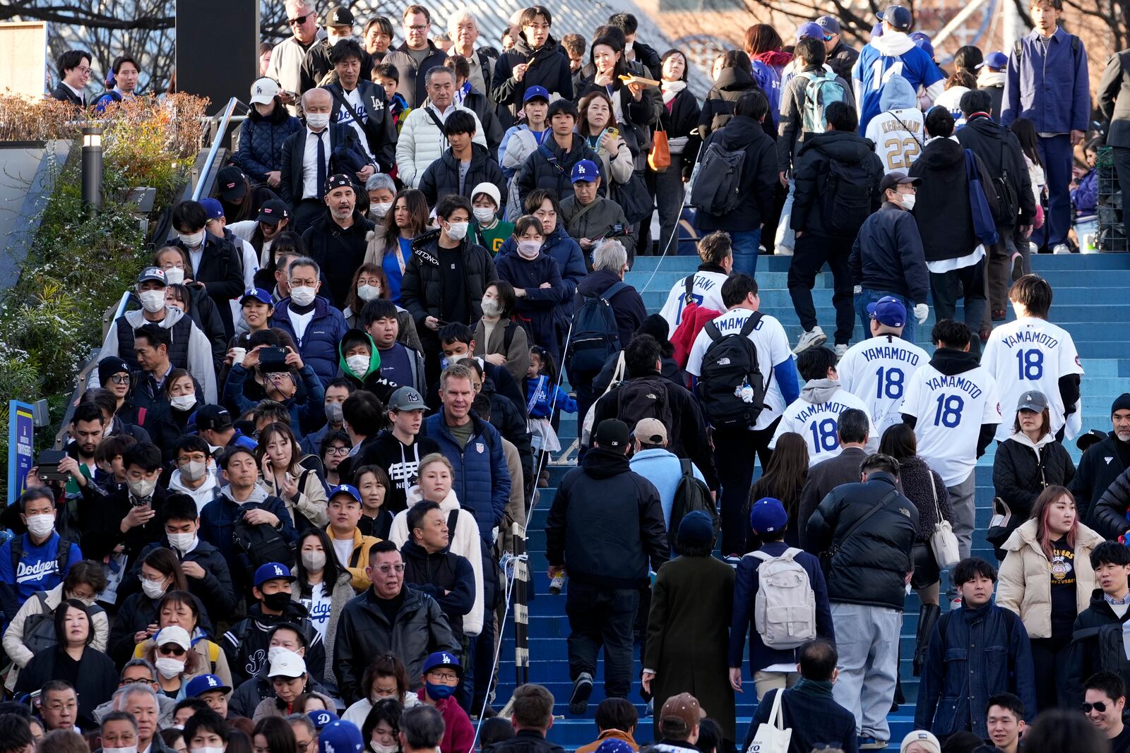 People, left side, wait in queue to enter an official shop before an MLB Japan Series baseball game between the Los Angeles Dodgers and the Chicago Cubs at Tokyo Dome, in Tokyo, Tuesday, March 18, 2025. (AP Photo/Shuji Kajiyama)