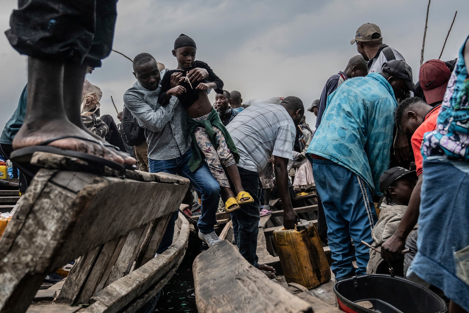 People fleeing M-23 rebel advances arrive by boat in Goma, Democratic Republic of the Congo, Wednesday, Jan. 22, 2025. (AP Photo/Moses Sawasawa)