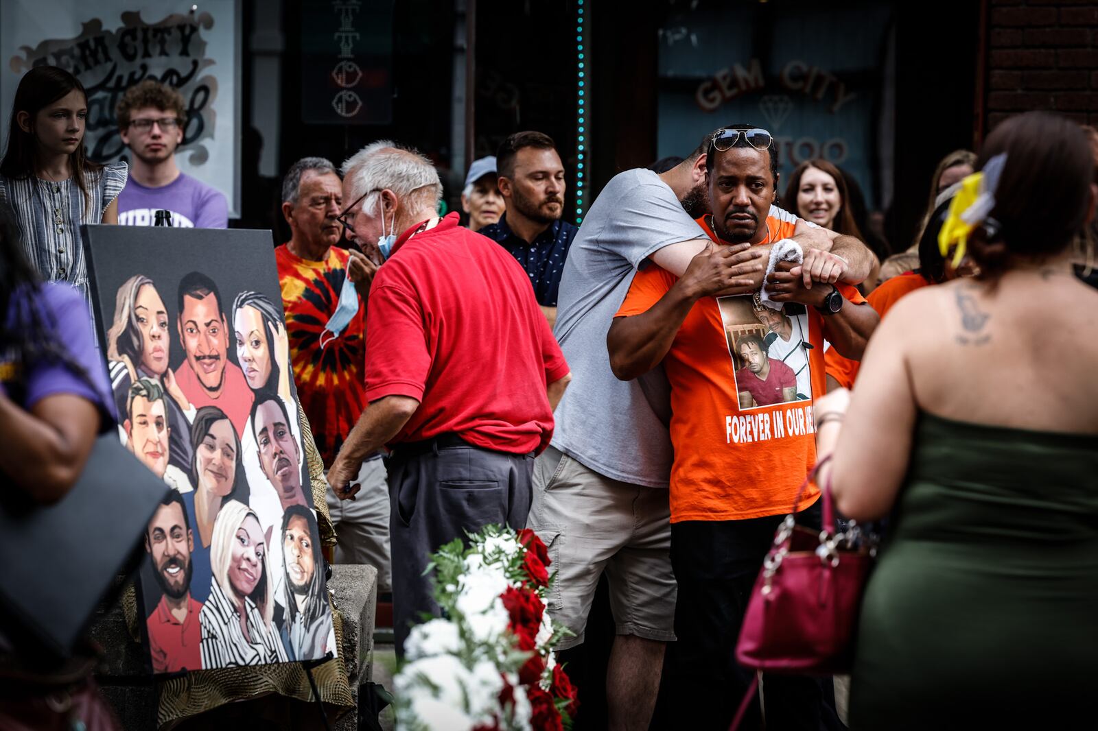 Dion Green gets a hug from Steve Beverly on Thursday, Aug. 4, 2022, after breaking down in tears talking about his father, who was one of nine victims who died during the mass shooting in the Oregon District in Dayton. Green organized the remembrance to mark the third anniversary of the tragedy through the FUDGE Foundation, which he started in honor of his father, 57-year-old Derrick Fudge of Springfield. JIM NOELKER/STAFF