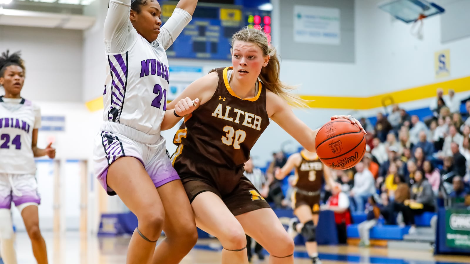 Alter High School junior Maddie Moody drives past Africentric senior Natiah Nelson during their game on Saturday afternoon at Springfield High School. The Nubians won 49-46. CONTRIBUTED PHOTO BY MICHAEL COOPER