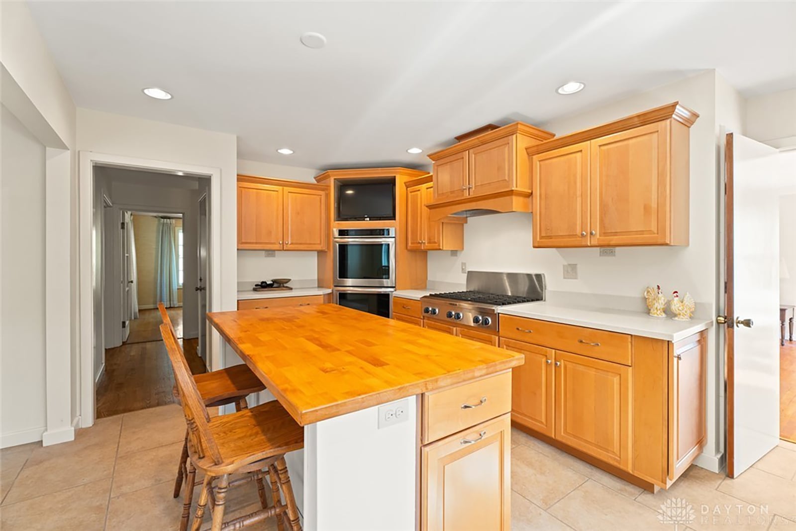 The updated chef's style kitchen has newer top of the line appliances, an island with breakfast bar and a breakfast nook.