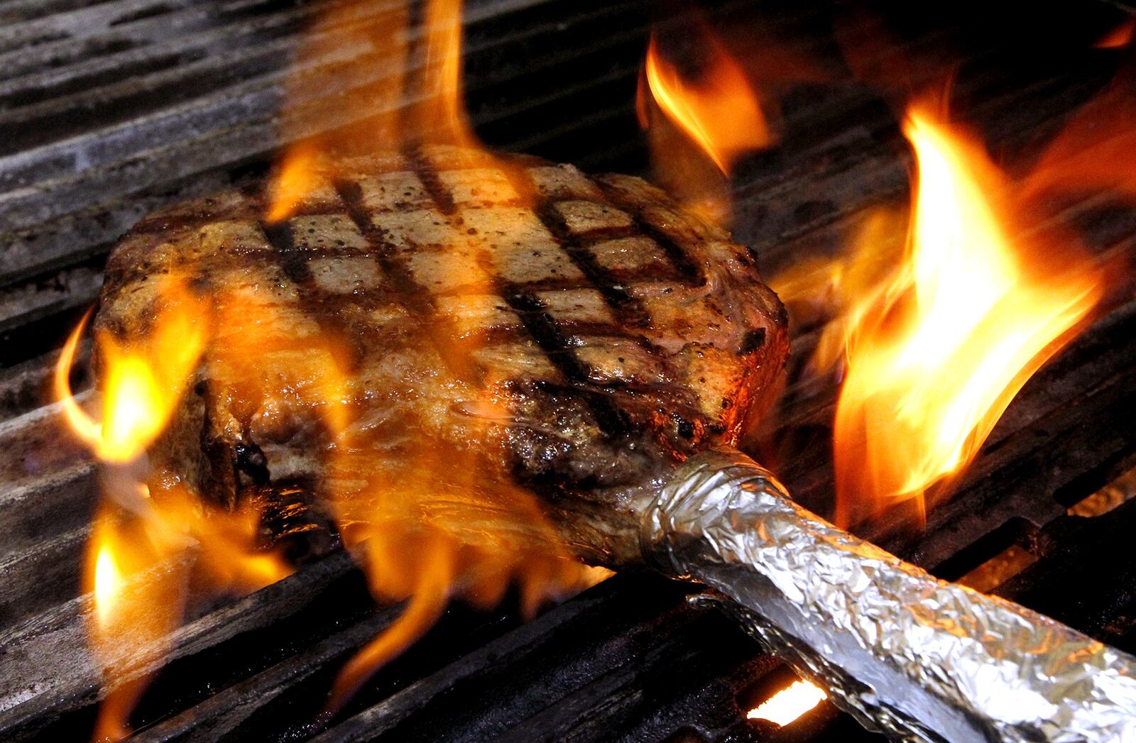 A ribeye steak sizzling on the grill at the Cecil and Lime Cafe. Bill Lackey/Staff