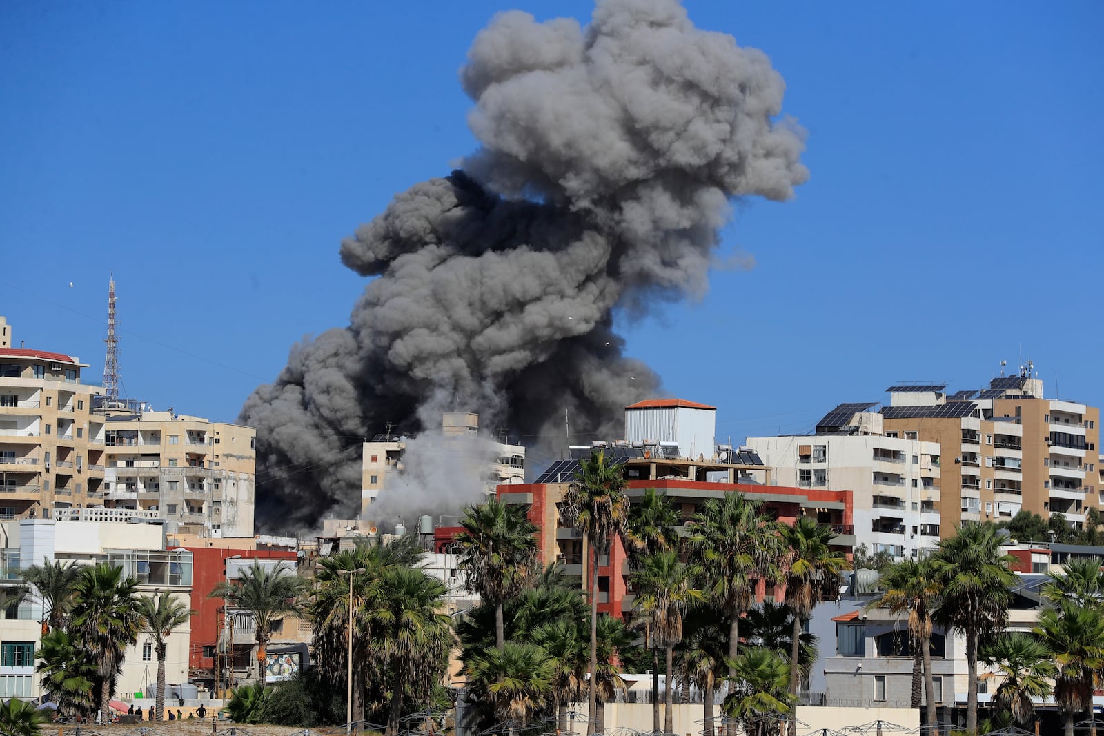 Smoke rises from buildings hit in an Israeli airstrike in Tyre, Lebanon, Wednesday, Oct. 23, 2024. (AP Photo/Mohammad Zaatari)