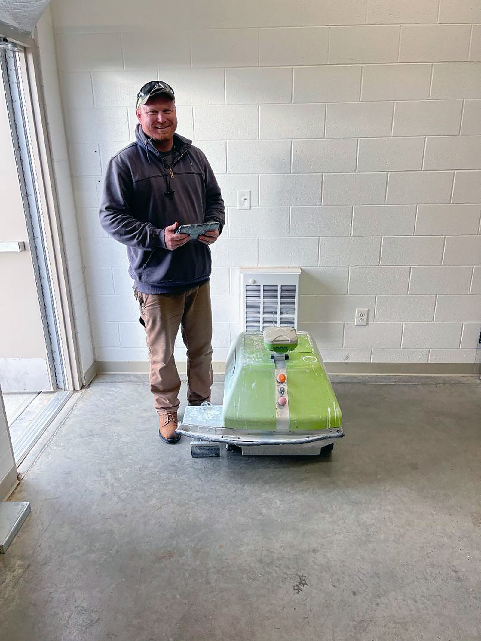 Facilities Manager Britt Barry with the Turf Tank robot painter. Warren County uses this robot to paint accurate lines on the sports fields, freeing up time for staff to attend to other responsibilities. CONTRIBUTED