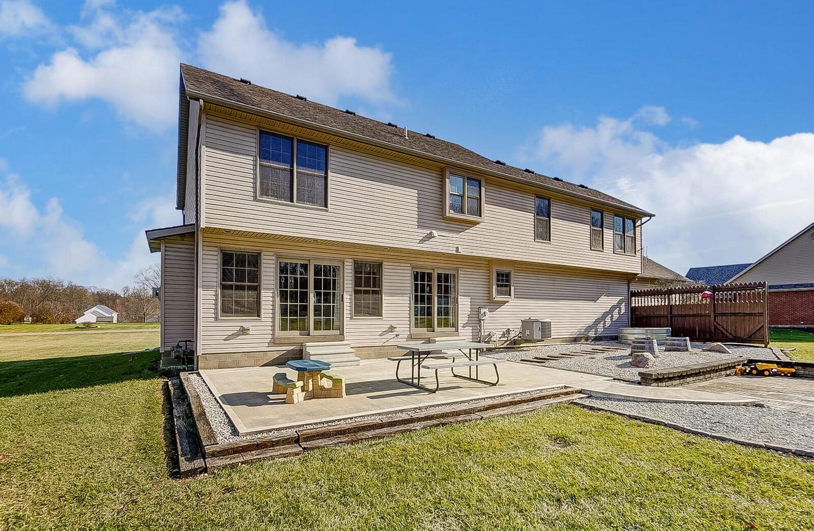 The rear of the home features additional hardscaping, a partial wood privacy fence and an oversized concrete patio. CONTRIBUTED