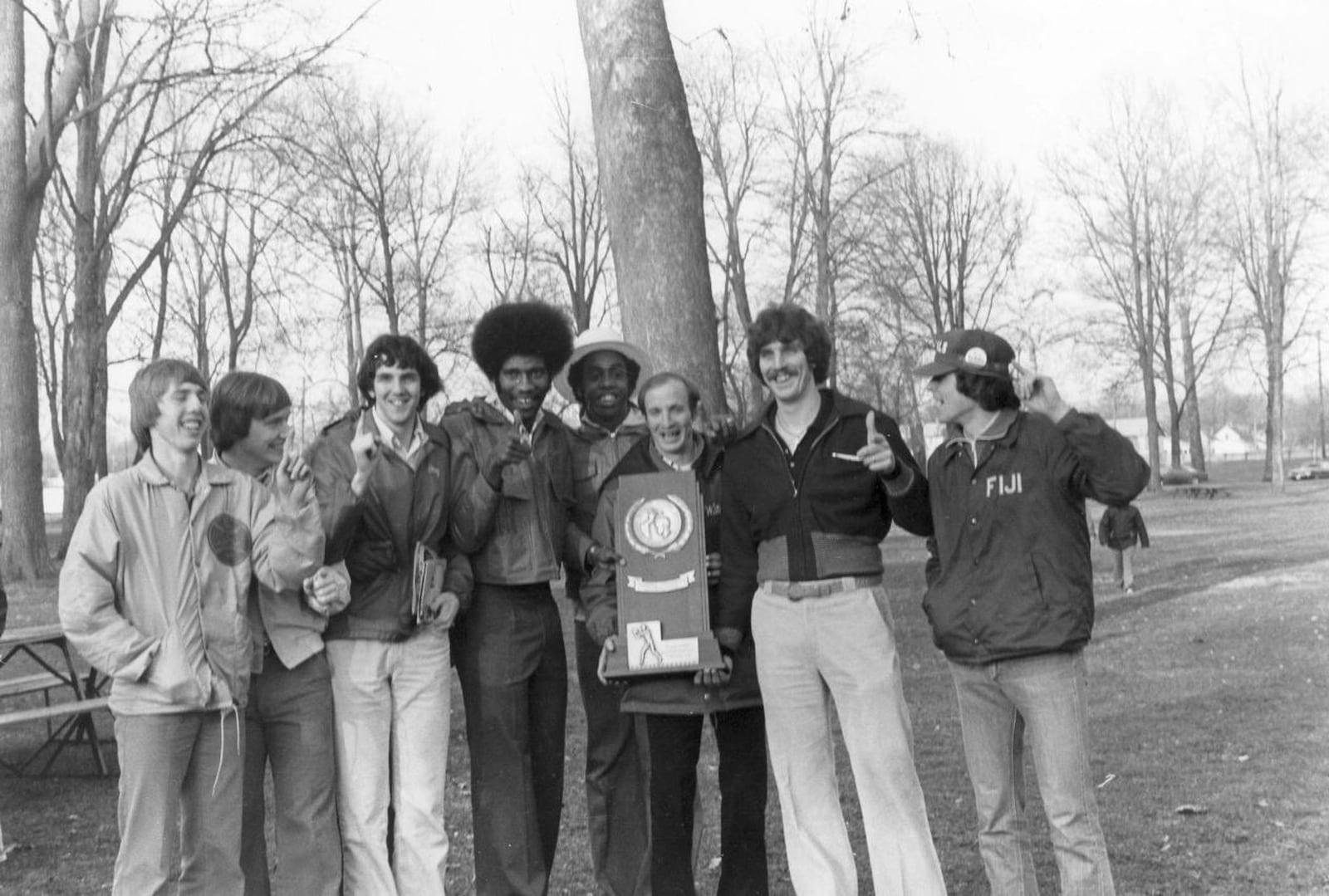 Wittenberg’s Larry Hunter holds the 1977 national championship photo and poses for a photo with players, including Brian Agler, far left, in Springfield. Wittenberg photo