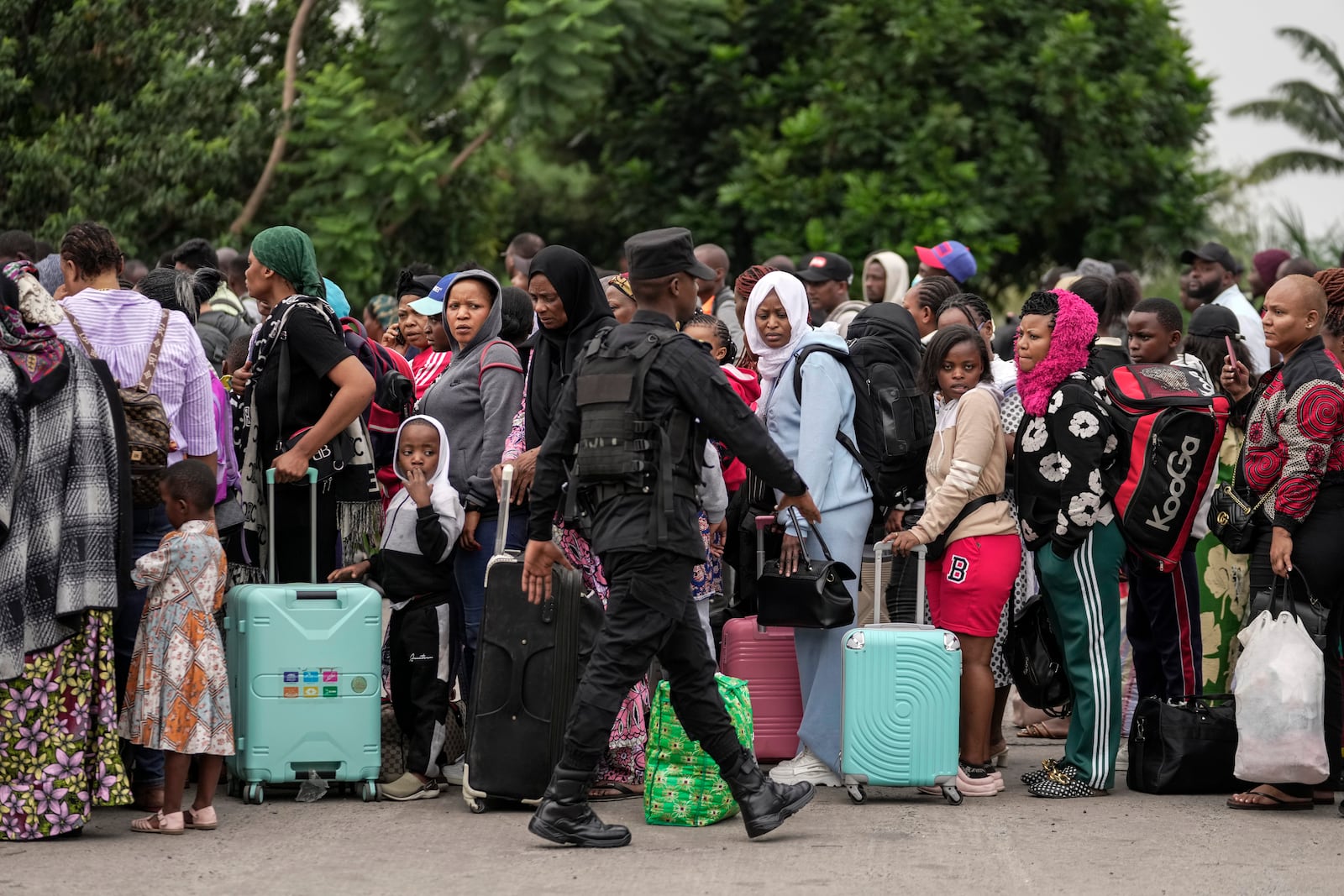 Rwanda security officials check people crossing from Congo in Gisenyi, Rwanda Rwanda, Wednesday, Jan. 29, 2025, following M23 rebels' advances into eastern Congo's capital Goma. (AP Photo/Brian Inganga)