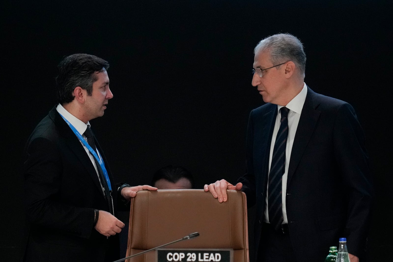 Yalchin Rafiyev, Azerbaijan's COP29 lead negotiator, left, talks to Mukhtar Babayev, COP29 President, ahead of a plenary session at the COP29 U.N. Climate Summit, Sunday, Nov. 24, 2024, in Baku, Azerbaijan. (AP Photo/Rafiq Maqbool)