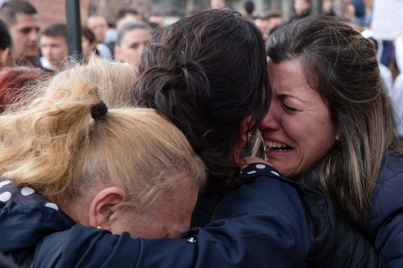 Women cry during a vigil for the victims of a massive nightclub fire in the town of Kocani, North Macedonia, Monday, March 17, 2025. (AP Photo/Visar Kryeziu)