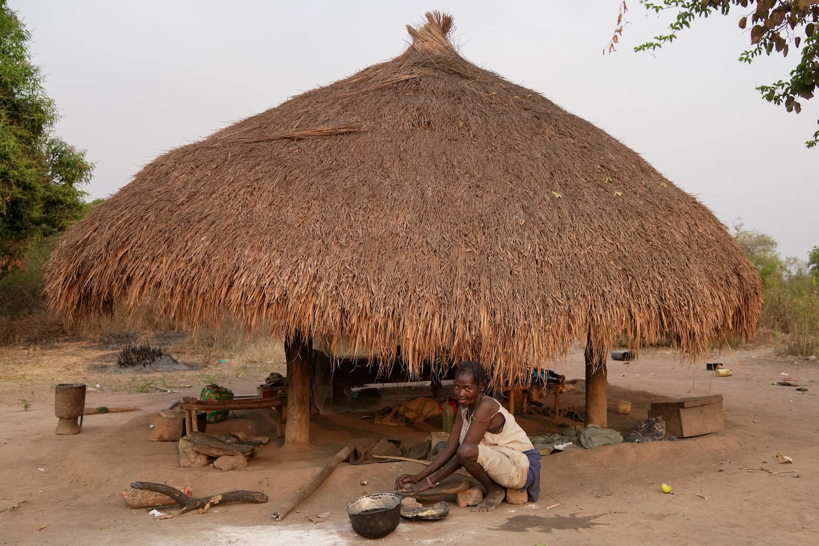 A woman works with flour near Nzara, South Sudan on Saturday, Feb. 15, 2025. (AP Photo/Brian Inganga)