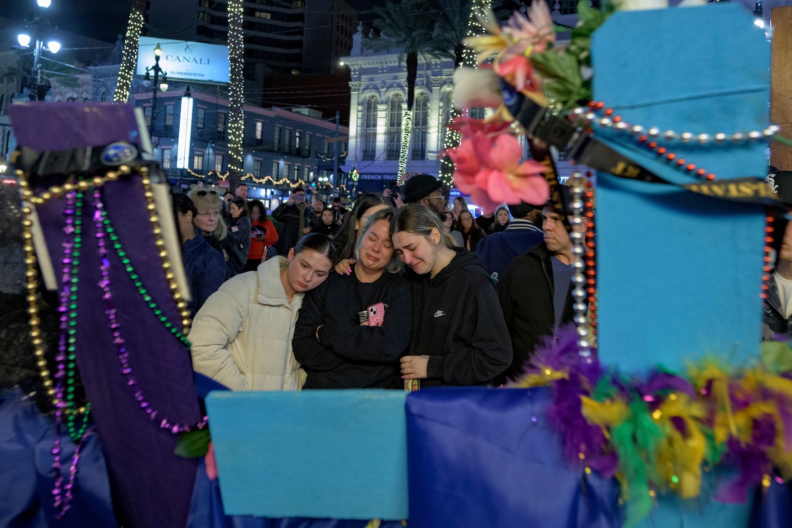 FILE - Mourners react next to crosses memorializing the victims of the New Year's Day deadly truck attack and shooting along Canal Street near the intersection of Bourbon Street in New Orleans, Saturday, Jan. 4, 2025. (AP Photo/Matthew Hinton, FILE)