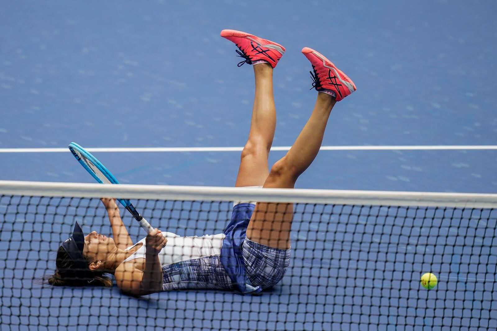 Tsvetana Pironkova, of Bulgaria, falls to the court during a match against Serena Williams, of the United States, during the quarterfinals of the US Open tennis championships, Wednesday, Sept. 9, 2020, in New York. (AP Photo/Seth Wenig)