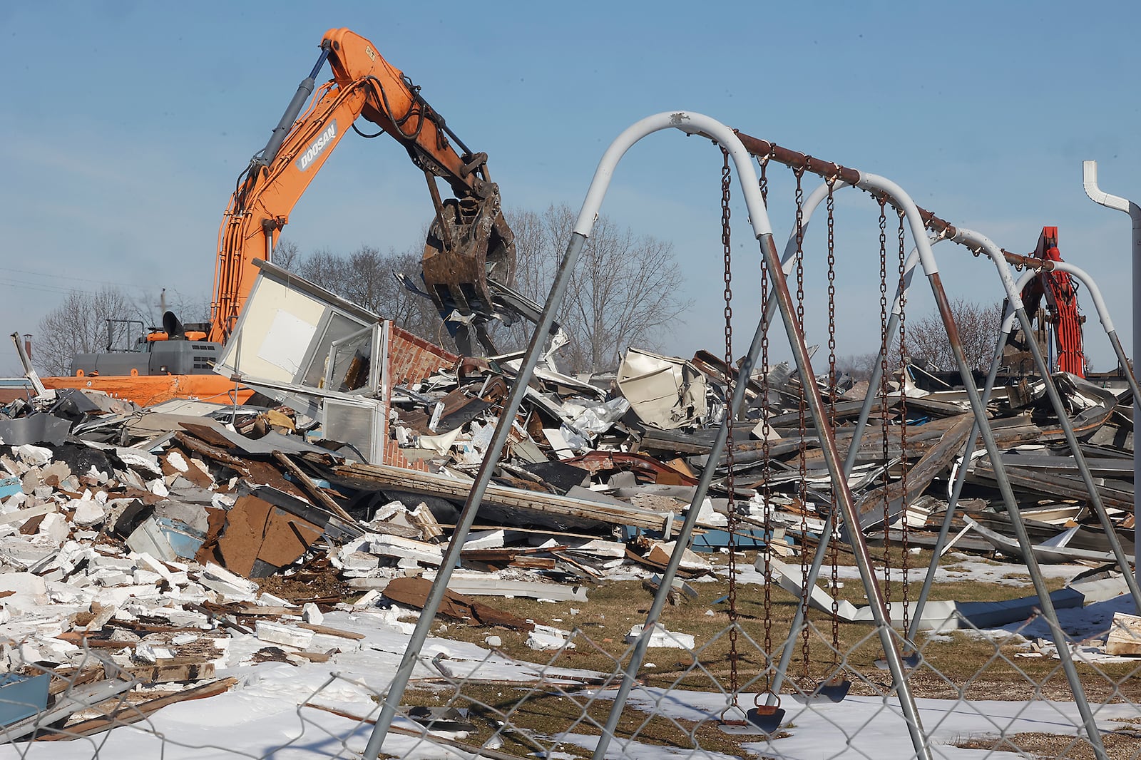 A demolition crew tears down Northridge Elementary/Middle School Monday, Feb. 19, 2024. The school has been empty since the students moved into a combined Kenton Ridge School at the beginning of the school year. BILL LACKEY/STAFF