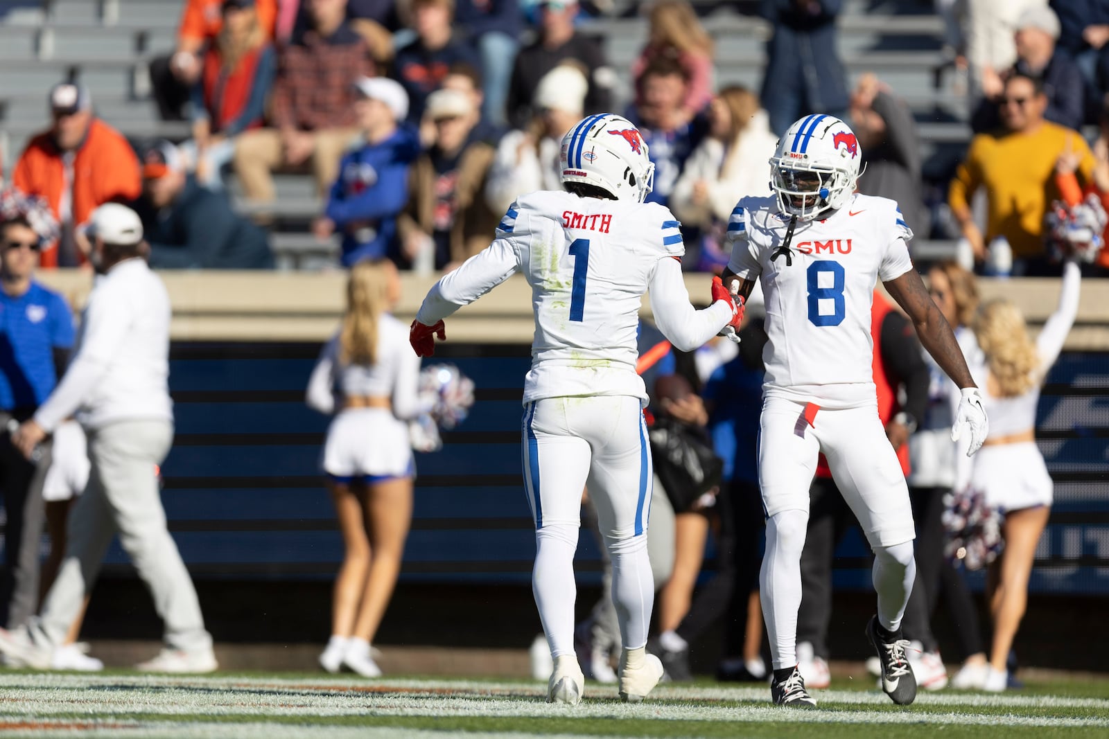 Southern Methodist running back Brashard Smith (1) and wide receiver Jordan Hudson (8) celebrate during the first half of an NCAA college football game against Virginia, Saturday, Nov. 23, 2024, in Charlottesville, Va. (AP Photo/Mike Kropf)