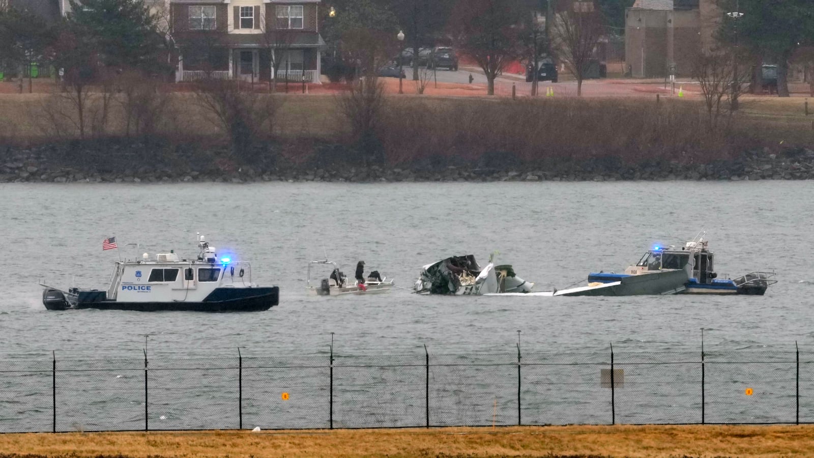 Search efforts are seen around a wreckage site of a deadly midair collision between an American Airlines jet and an Army helicopter, in the Potomac River near Ronald Reagan Washington National Airport, Friday, Jan. 31, 2025, in Arlington, Va. (AP Photo/Alex Brandon)