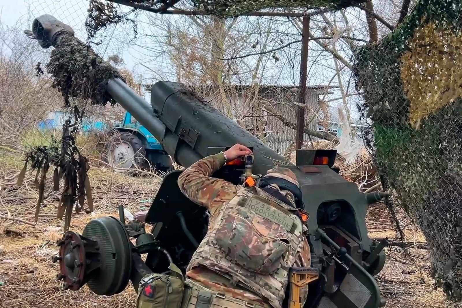 FILE - In this photo taken from a video released by Russian Defense Ministry press service on Nov. 29, 2024, a Russian serviceman aims a D-30 howitzer towards Ukrainian positions in the border area of Kursk region, Russia. (Russian Defense Ministry Press Service via AP, File)