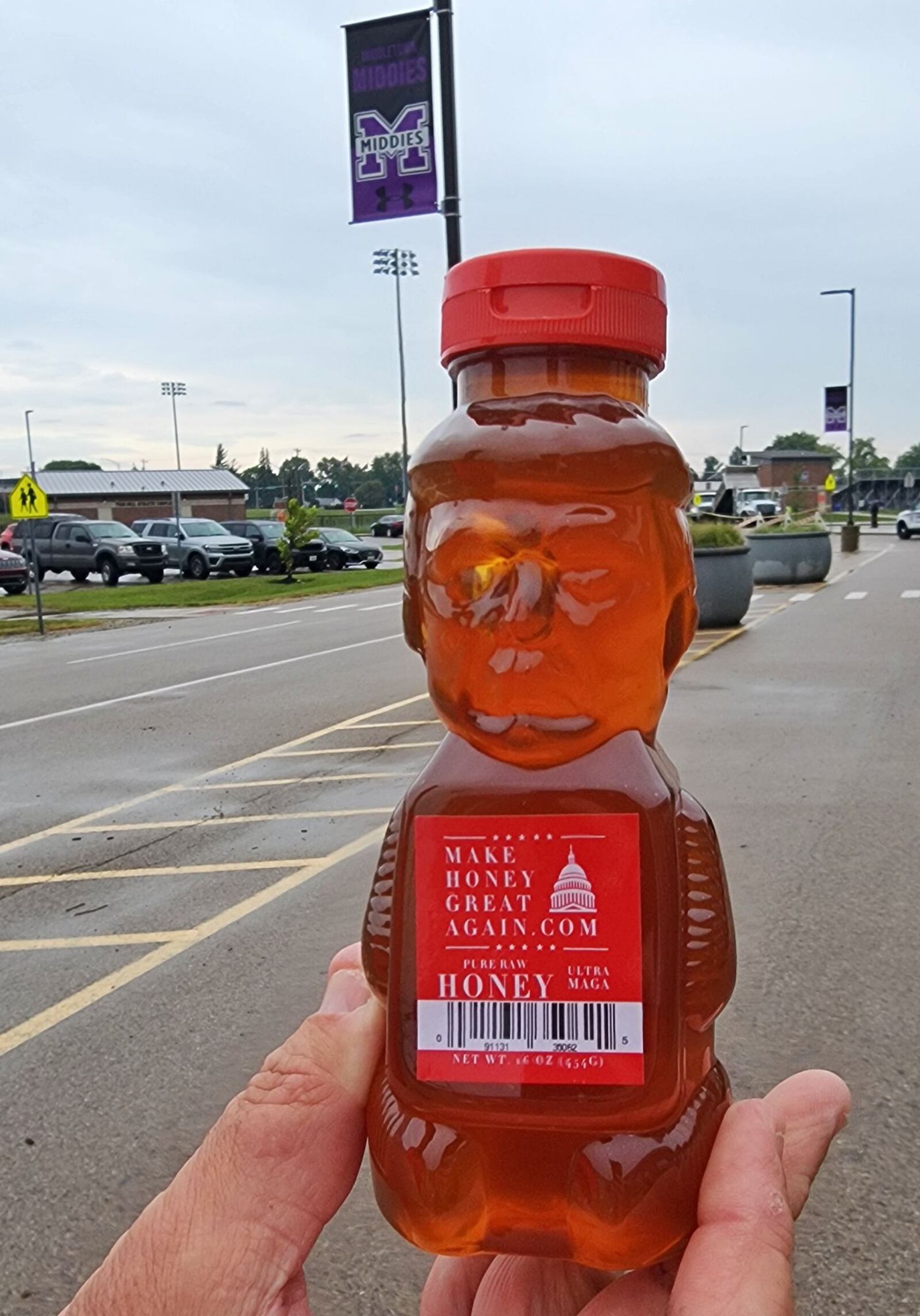 Todd Gerhart, who sells Trump honey, holds a bottle of his "Make Honey Great Again" honey at rally for Vice Presidential candidate J.D. Vance Monday, July 22, 2024 at Middletown High School. NICK GRAHAM/STAFF