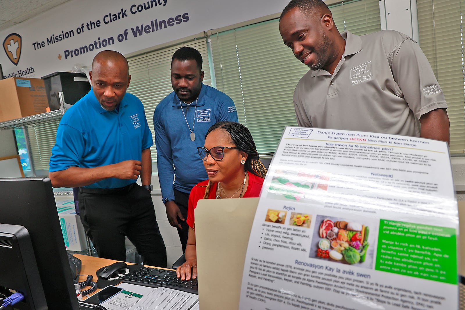 Haitian Creole interpreters at the Clark County Combined Health District, Daniel Vilmond, Rodolph Paul, Dorline Lucien and Luckens Merzius, look over an email they received in their office at the Health District Thursday, June 22, 2023. BILL LACKEY/STAFF