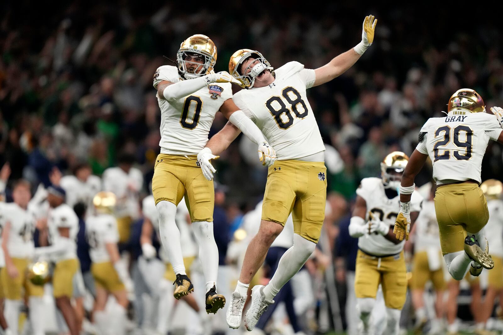 Notre Dame safety Xavier Watts (0) celebrates with teammate Armel Mukam (88) during the second half against Georgia in the quarterfinals of a College Football Playoff, Thursday, Jan. 2, 2025, in New Orleans. (AP Photo/Gerald Herbert)