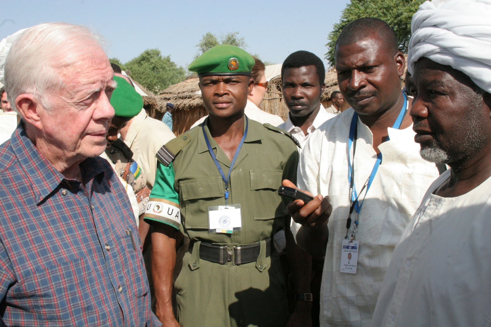 FILE - Former U.S. President Jimmy Carter meets representatives of ethnic African refugees in Kabkabiya town in Darfur, Oct. 3, 2007. The visit by "The Elders," which is headed by Carter and Nobel Peace laureate Desmond Tutu, is largely a symbolic move by a host of respected figures to push all sides to make peace in Darfur. (AP Photo/Alfred de Montesquiou, File)