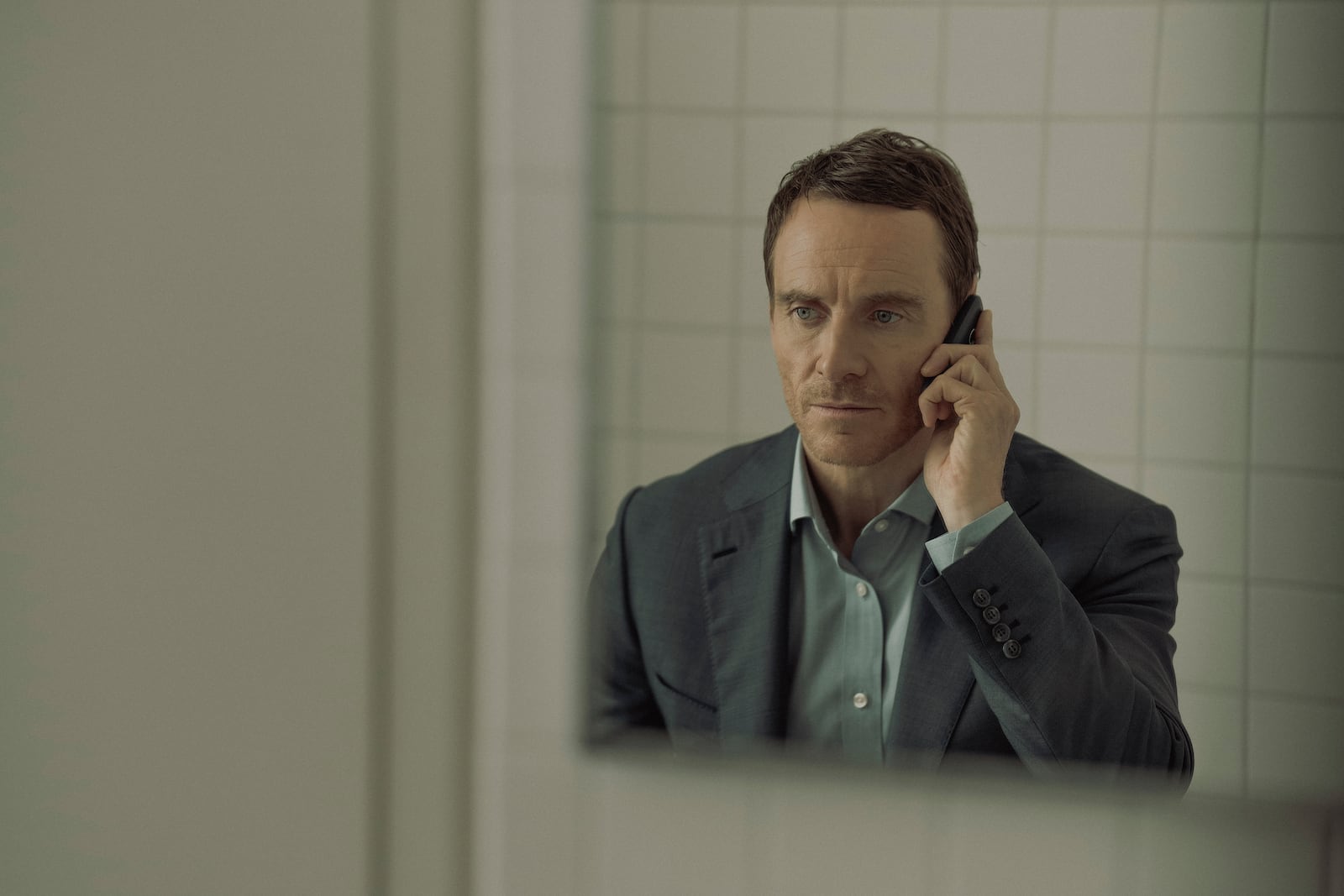 This image released by Paramount+ shows Michael Fassbender in a scene from "The Agency." (Luke Varley/Paramount+ via AP)